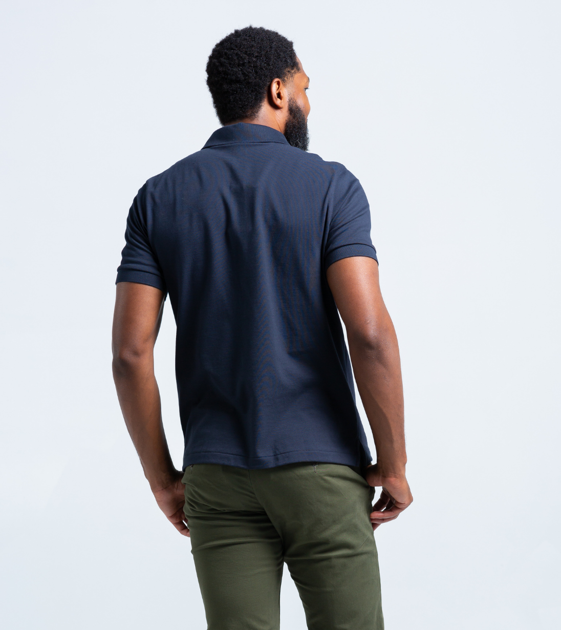 Back view of a man wearing the Short Sleeve Perfect Polo in navy, showcasing StaySharp™ Collar and wrinkle-free fabric.