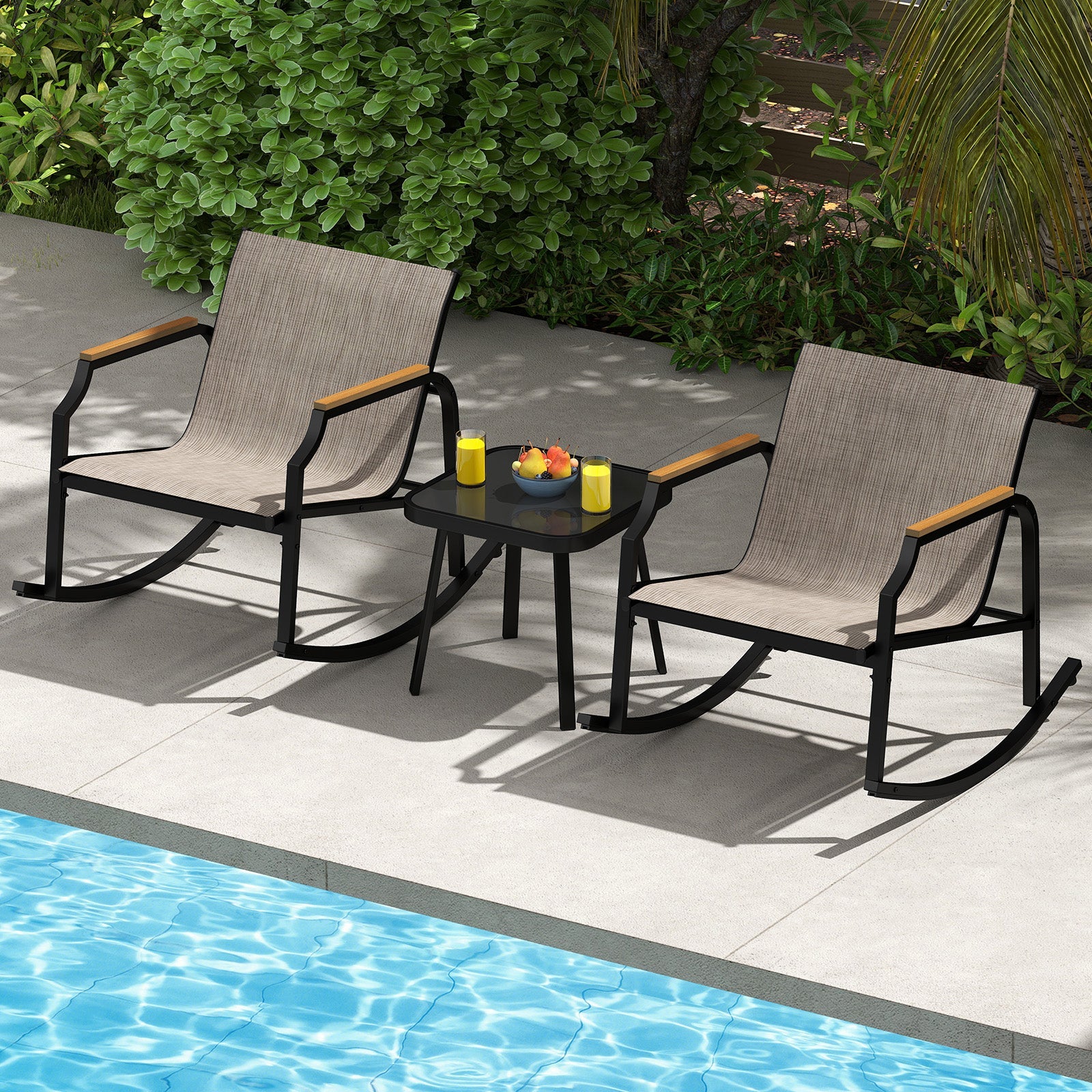 3 Piece Patio Rocking Bistro Set with Tempered Glass Coffee Table and Armrests for Porch-Brown, beside a swimming pool.