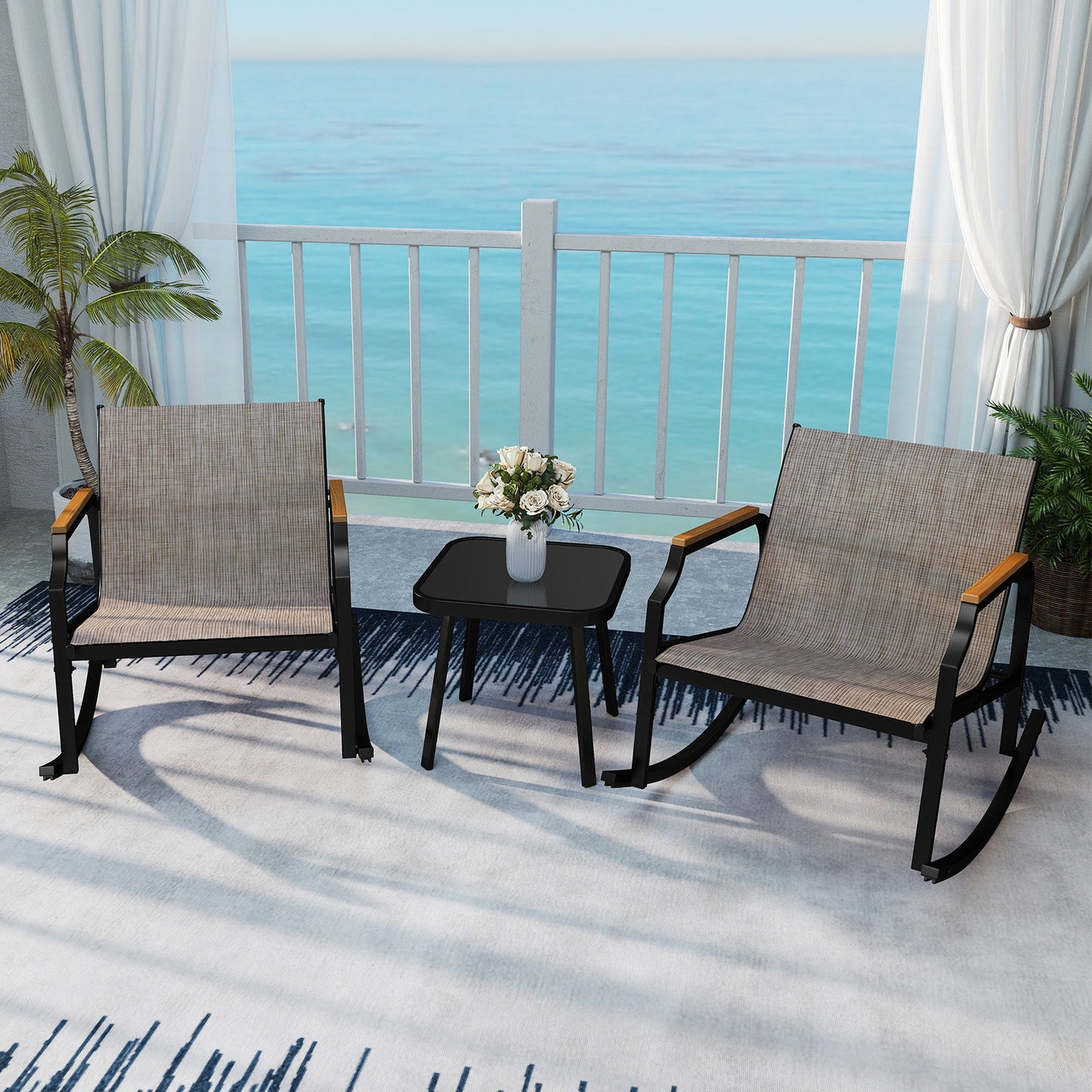 3 Piece Patio Rocking Bistro Set with Tempered Glass Coffee Table and Armrests for Porch-Brown on a seaside porch