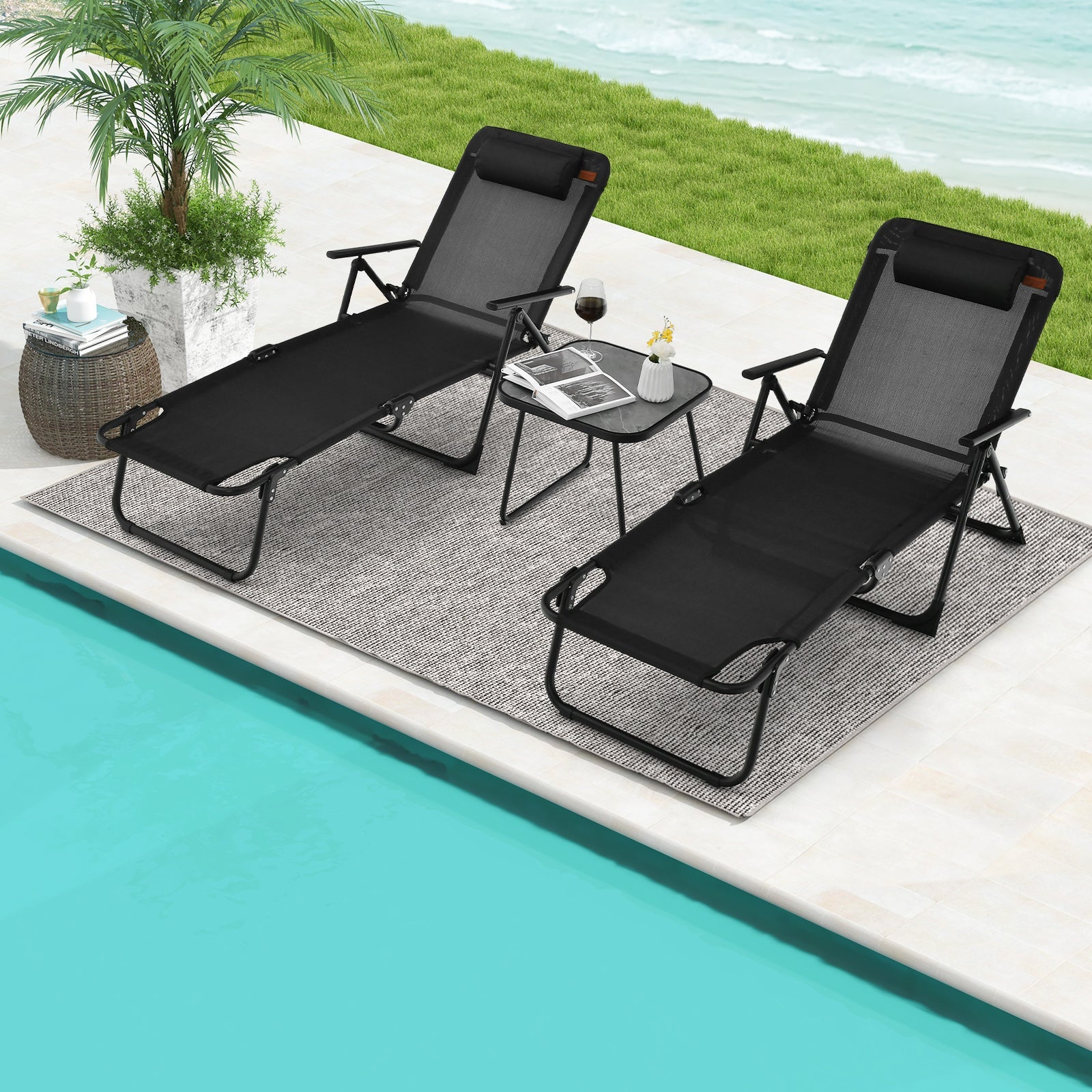 3 Pieces Patio Folding Chaise Lounge Set with PVC Tabletop-Black by the poolside on a carpet with drinks and plant.
