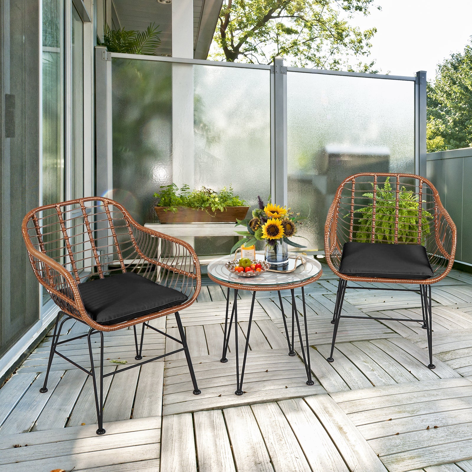 3 Pieces Patio Rattan Bistro Set with Cushion-Black on wooden deck with sunflowers and outdoor scenery