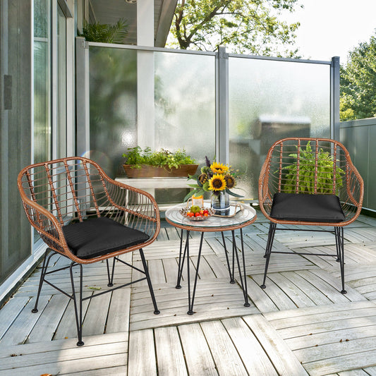 3 Pieces Patio Rattan Bistro Set with Cushion-Black on wooden deck with sunflowers and outdoor scenery