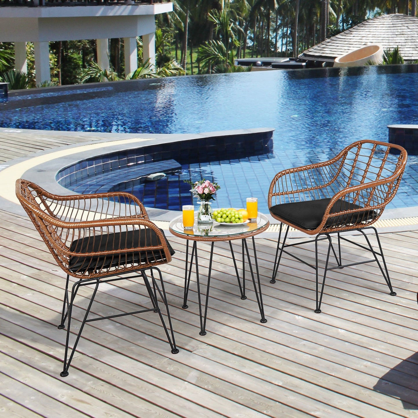 3 Pieces Patio Rattan Bistro Set with Cushion-Black by a poolside, featuring 2 armchairs, a side table, and soft black cushions.
