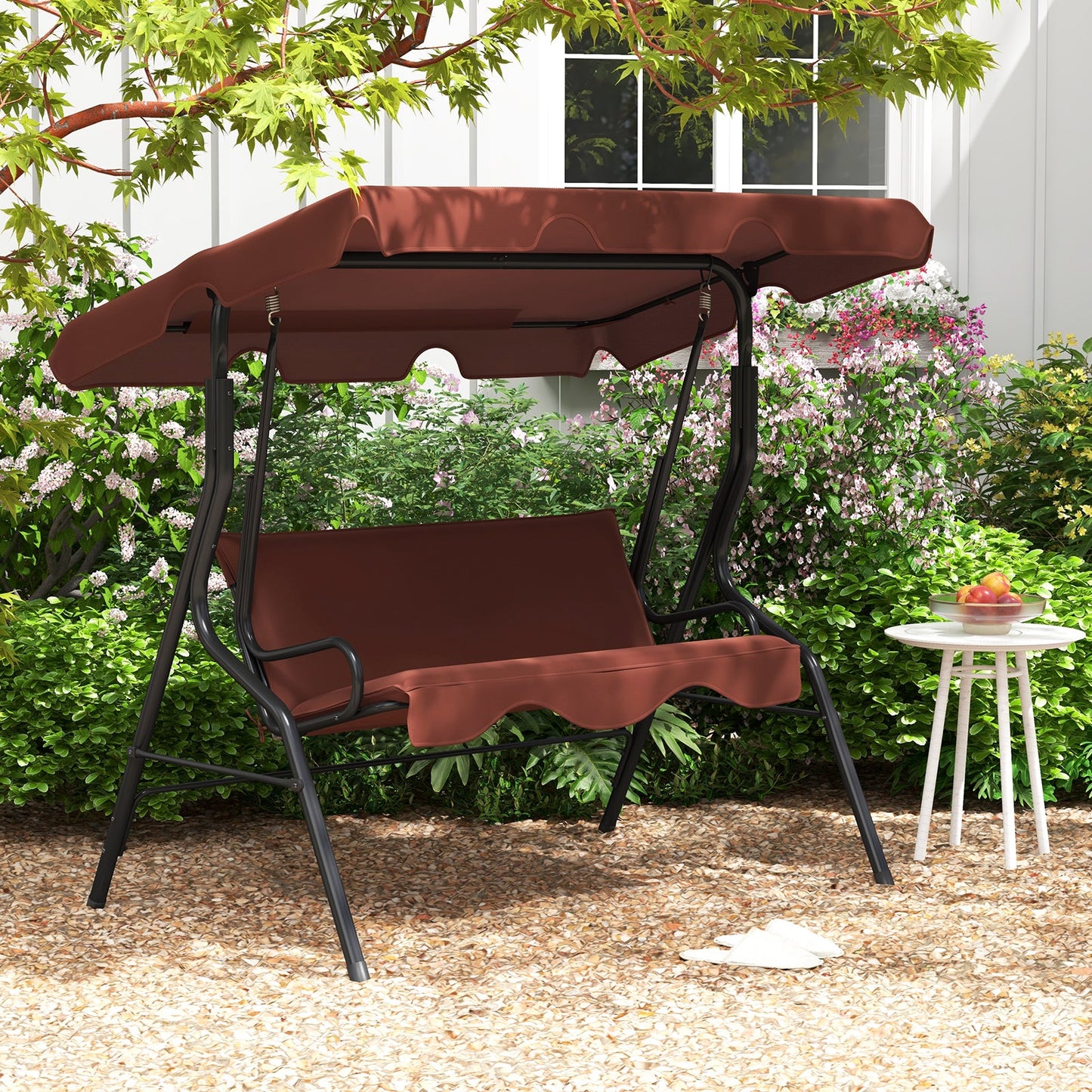 3 Seat Outdoor Patio Canopy Swing with Cushioned Steel Frame-Brown in garden setting