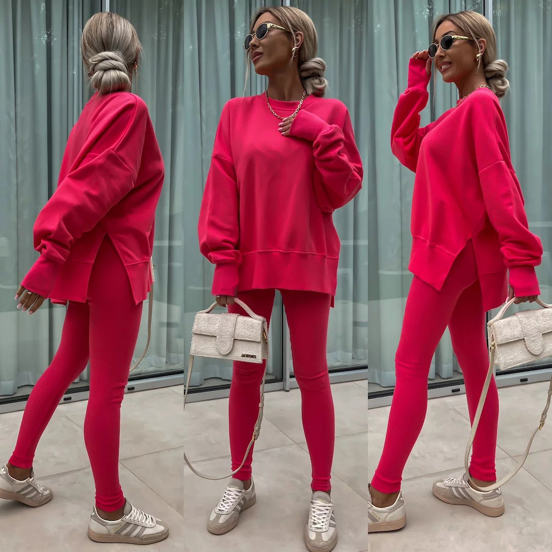 Woman wearing Women’s Casual Sweater Suit – Loose Split Top & Fitted Trousers Set in vibrant pink, styled with sneakers and a handbag.