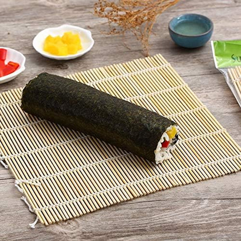 Bamboo Sushi Rolling Mat & Rice Paddle Set (3-Piece) with freshly rolled sushi, showcasing its traditional crafting elements.