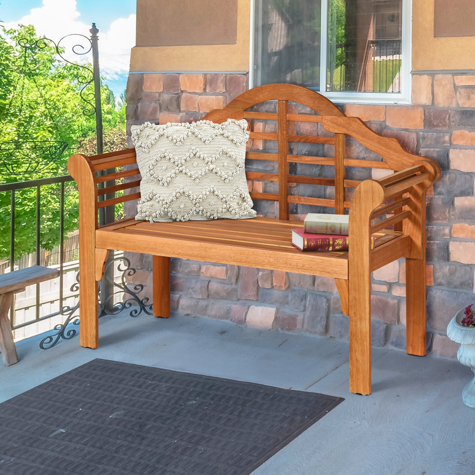 49 Inch Eucalyptus Wood Outdoor Folding Bench with Backrest Armrest for Patio Garden on a porch with pillow and book