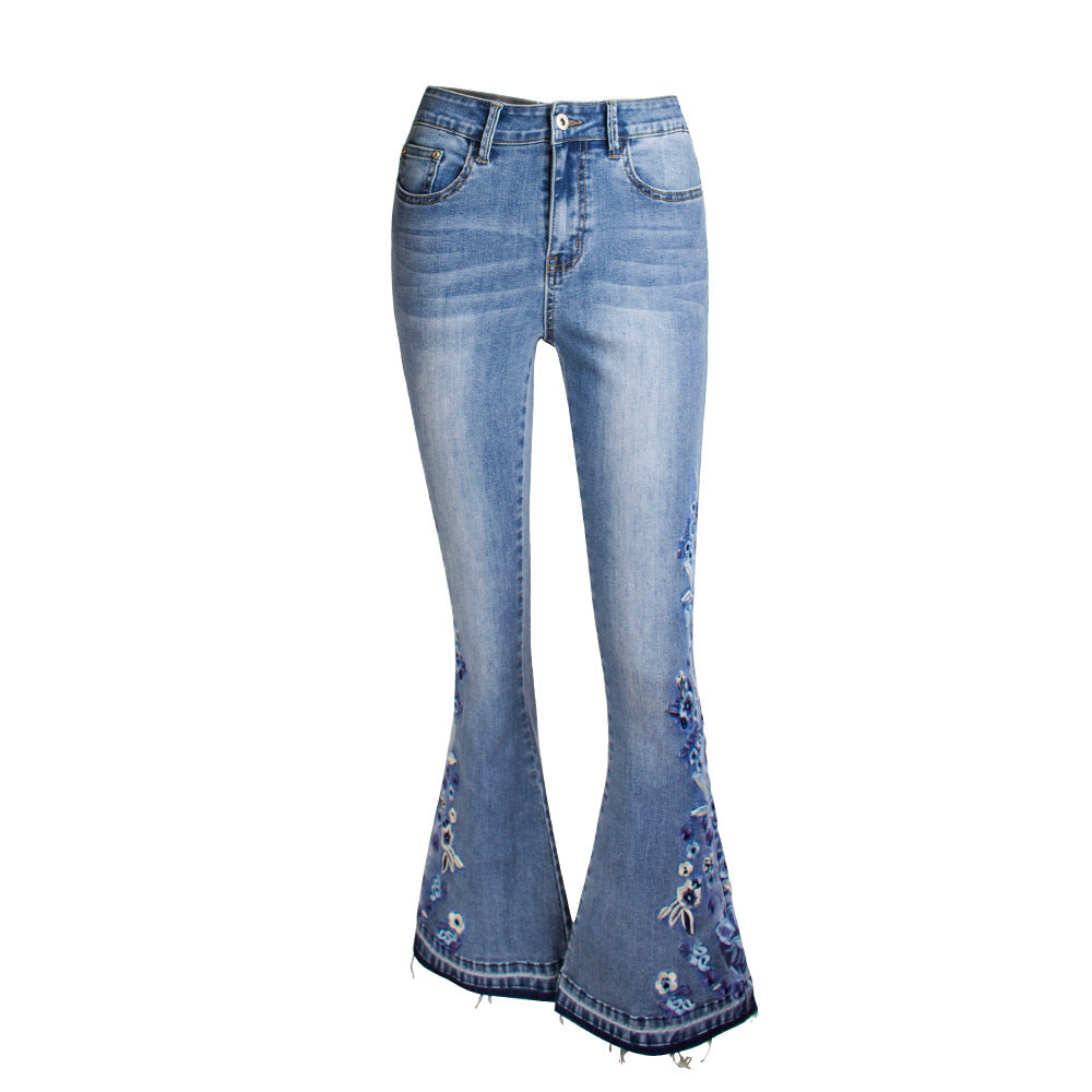 "Riley" Flared Denim Jeans in light blue with retro embroidered details and a mid-waist fit for vintage street style.