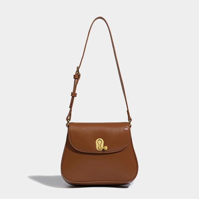 Luxury Retro Cowgirl Saddle Bag | Genuine Leather Brown Handbag with adjustable strap and gold buckle clasp, front view.