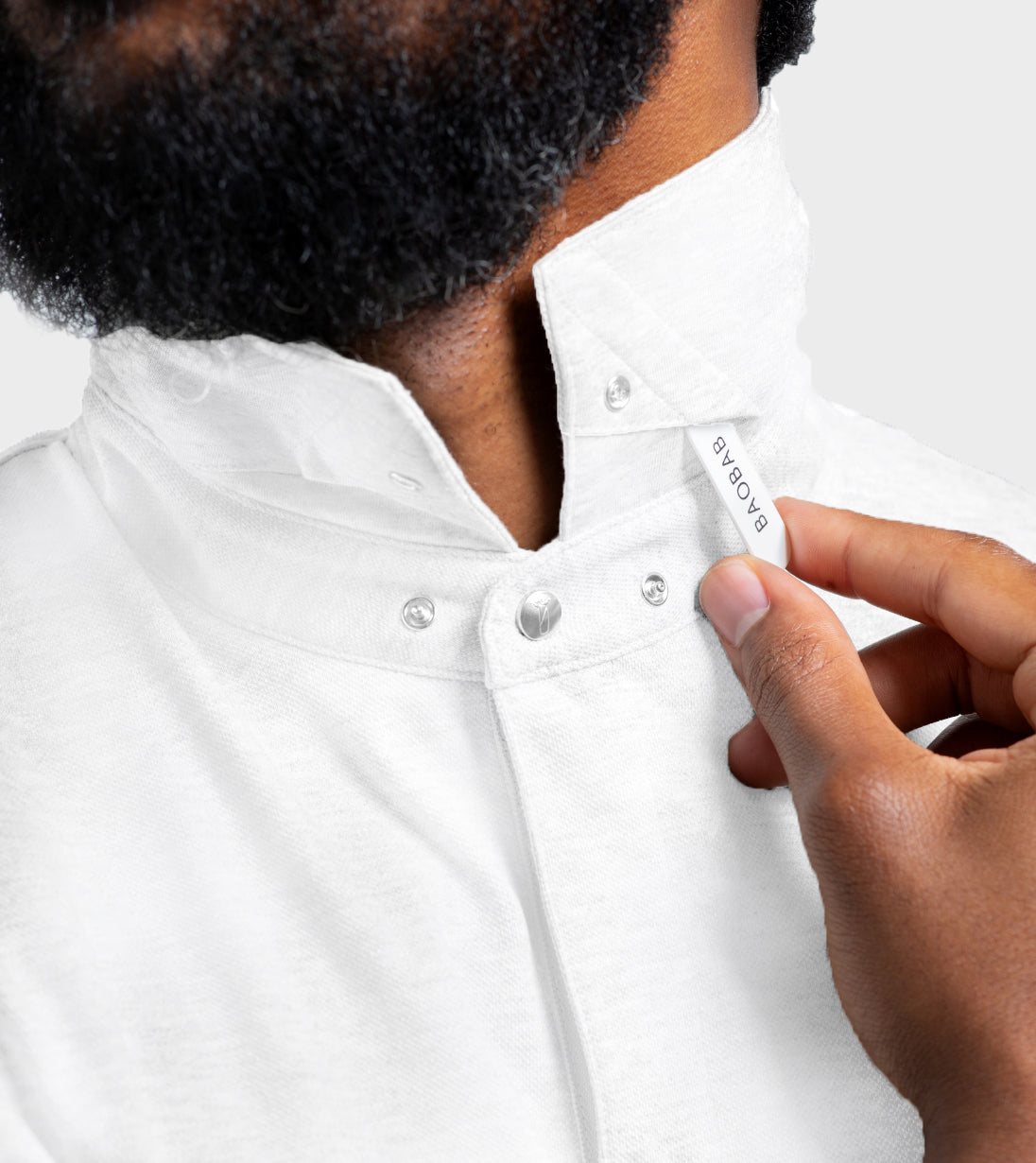White Short Sleeve Perfect Polo with StaySharp™ Collar and hidden snaps, featuring a handy microfiber cloth for cleaning glasses or screens.