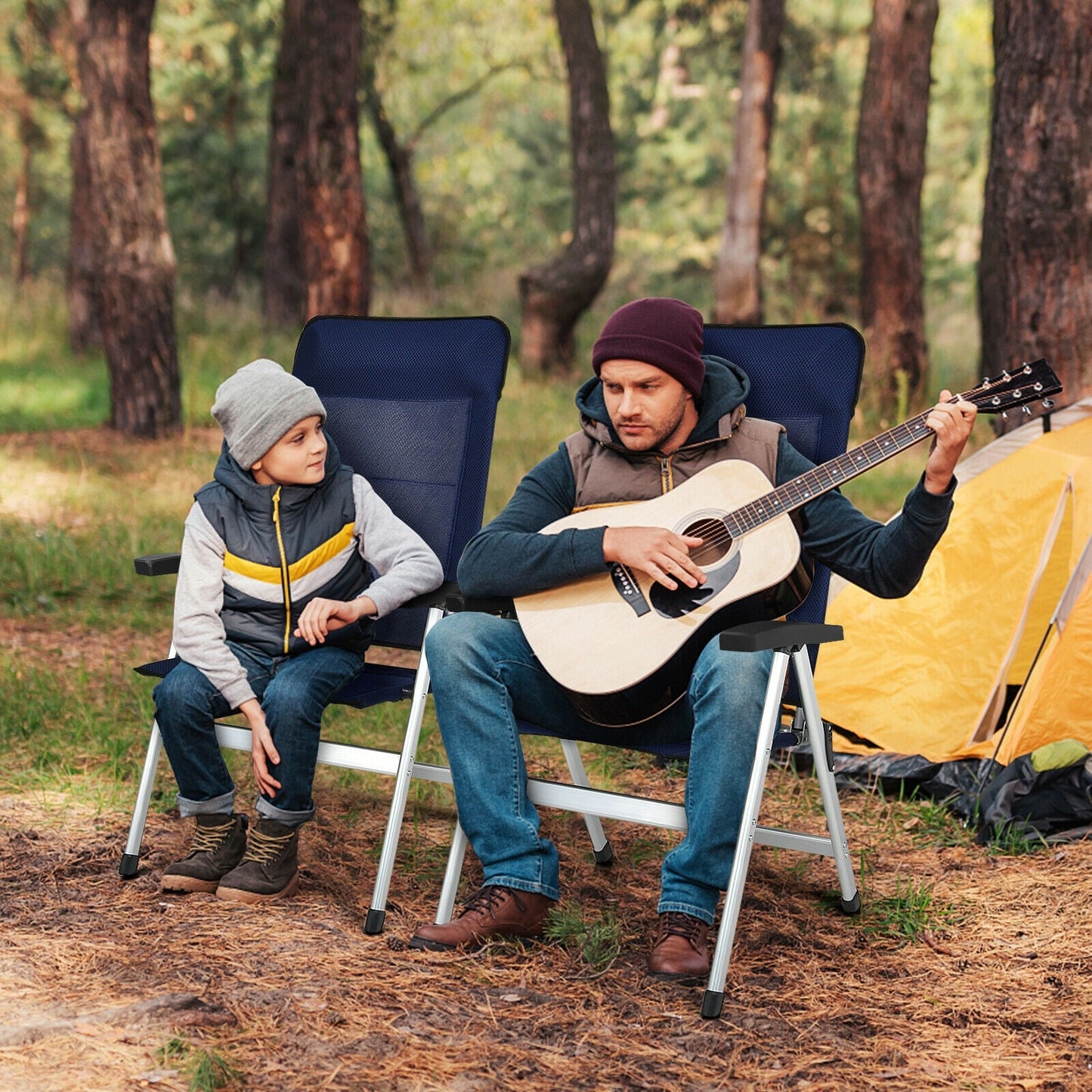 Father and son sitting on 2Pcs Patio Dining Chair with Adjust Portable Headrest-Blue while playing guitar outdoors near a yellow tent.