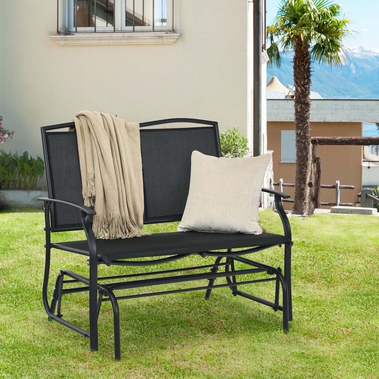 Iron Patio Rocking Chair for Outdoor Backyard and Lawn-Black with cushion and blanket on grass