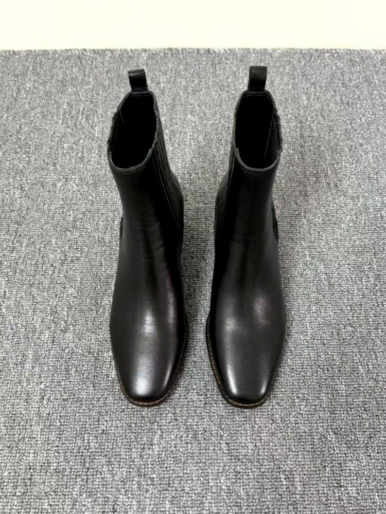 Women’s Retro Square-Toe Mid-Heel Chunky Leather Boots in black, featuring classic design and comfort on a grey textured surface.