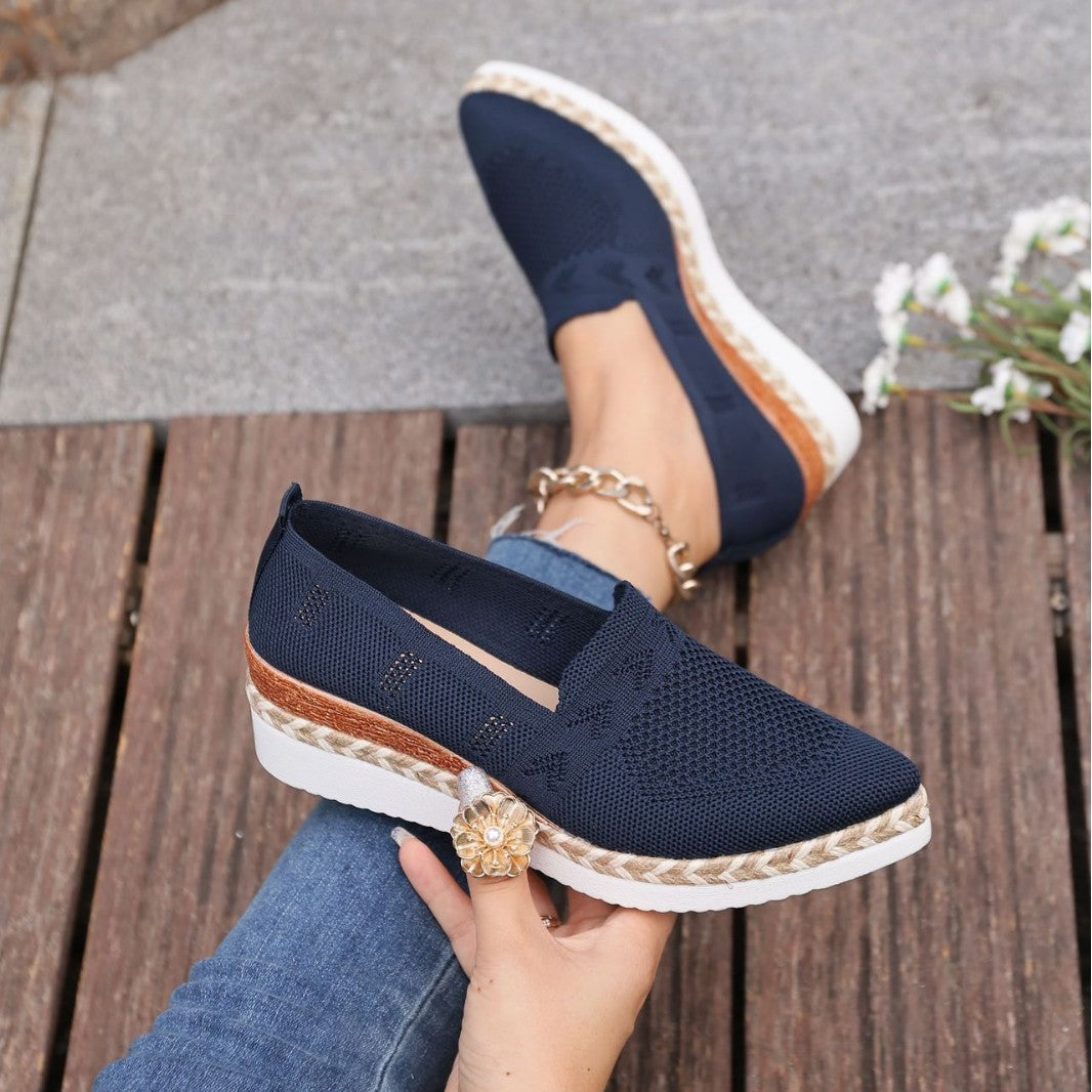 Women’s Woven Rope Platform Snakeskin Pointed-Toe Flats | Trendy Flats with hemp-rope sole and snakeskin finish on wooden deck.