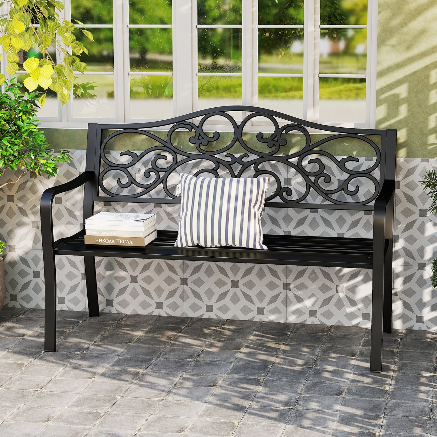 50 Inches Outdoor Garden Bench with Floral Design Backrest and Slatted Seat-Black on patio with cushion and books