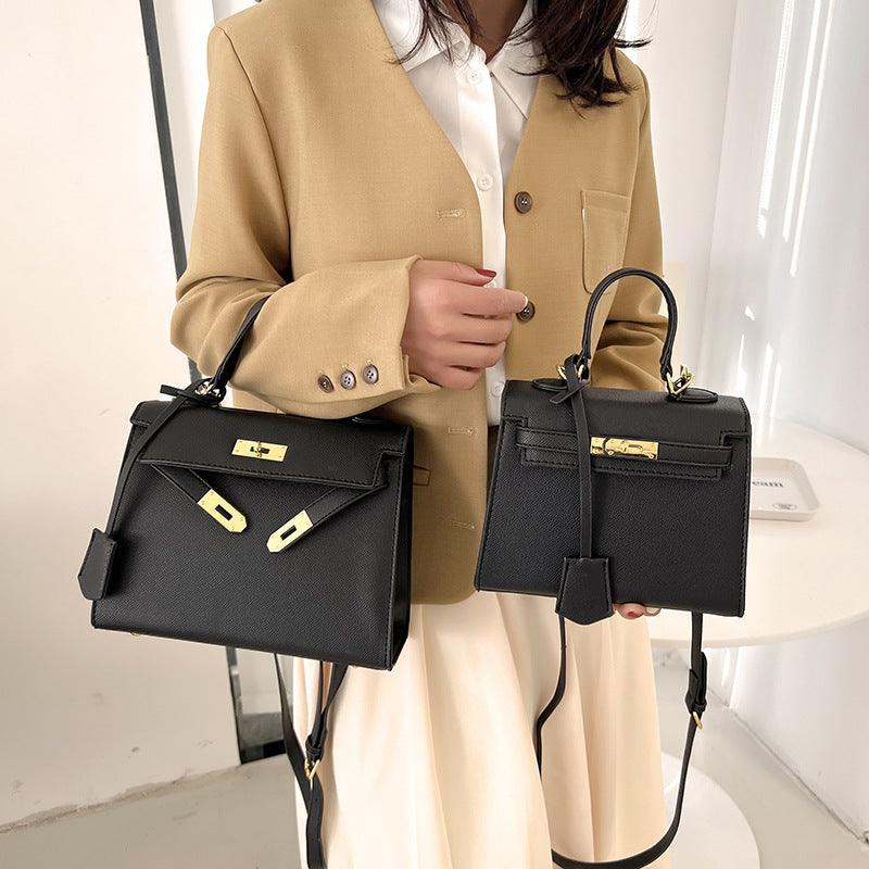Luxury Cowgirl Kelly Purse – Trendy, High-Fashion Leather Handbag with Adjustable Strap in black with buckle lock design.