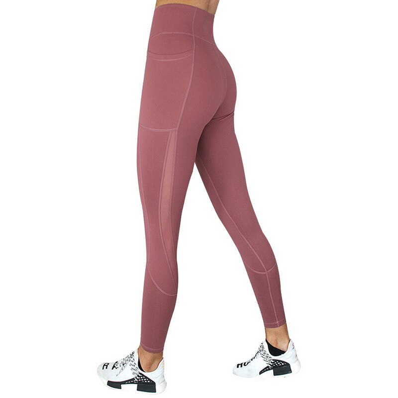 Back view of high-waisted Yoga Leggings with Phone Pocket in mauve, featuring mesh details and a stylish spliced pattern, worn with sneakers.