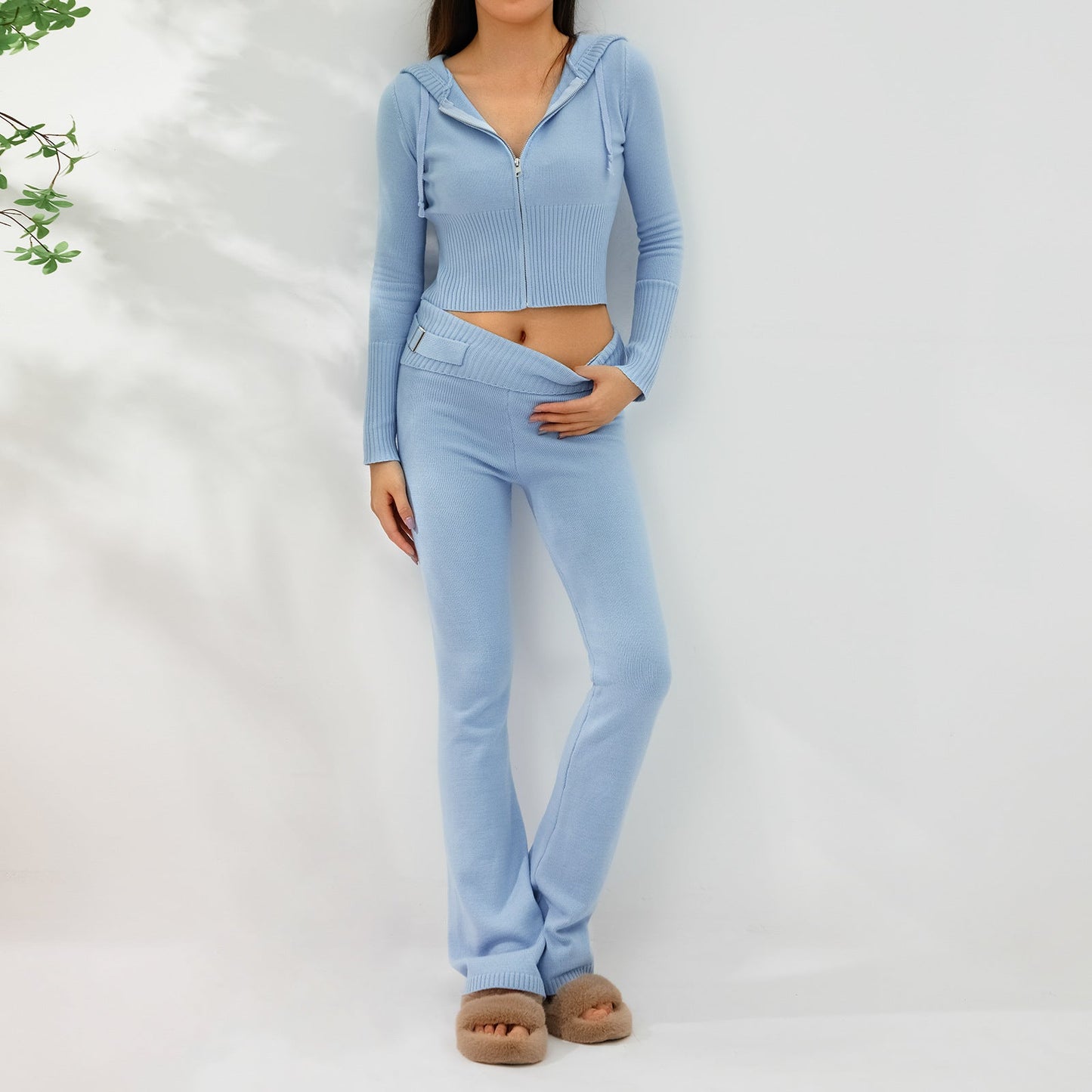 Model wearing Women's Knitted Hooded Two-Piece Set – Cardigan & High-Waisted Pants Suit in light blue color, showcasing fashion style.