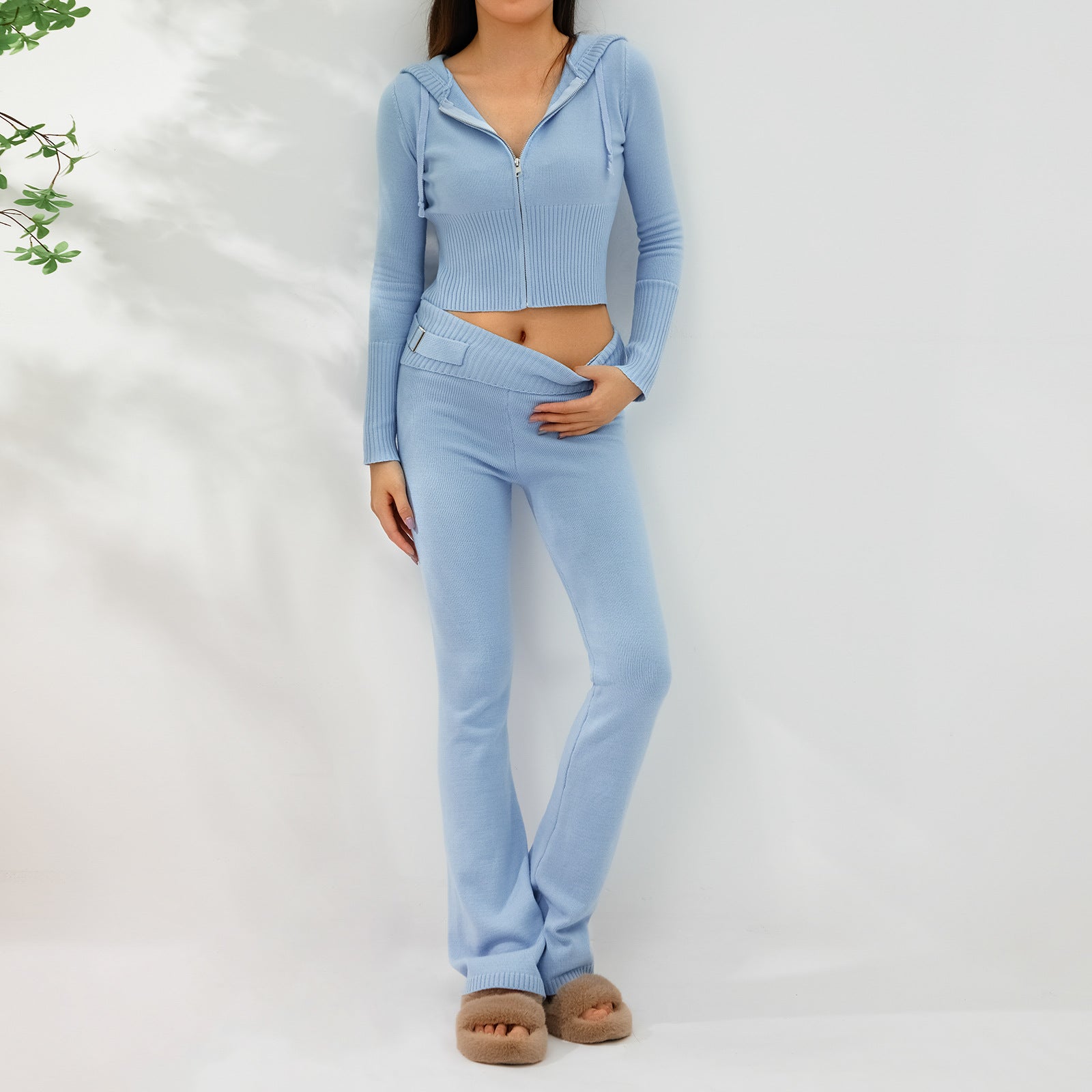 Model wearing Women's Knitted Hooded Two-Piece Set – Cardigan & High-Waisted Pants Suit in light blue color, showcasing fashion style.