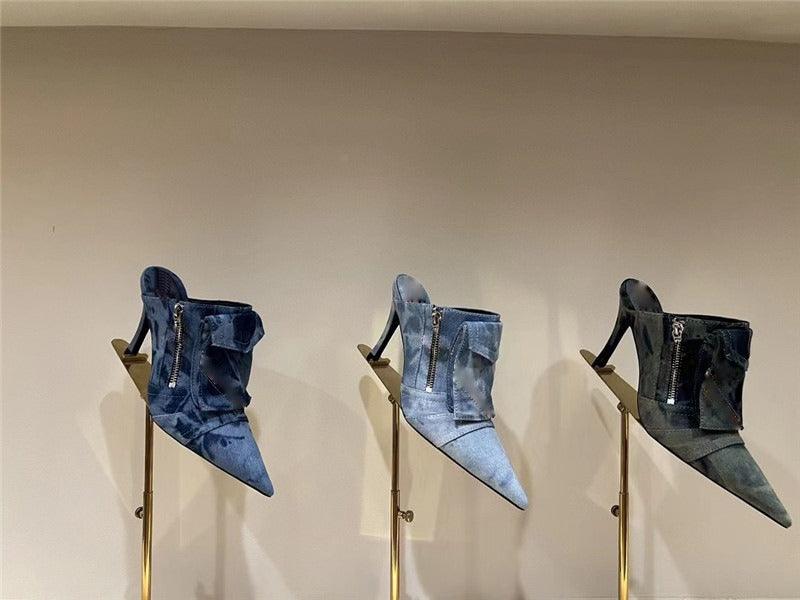 Women Pocket Denim Pointed Toe Heeled Ankle Boots in blue, displayed on stands, showcasing modern and elegant design.