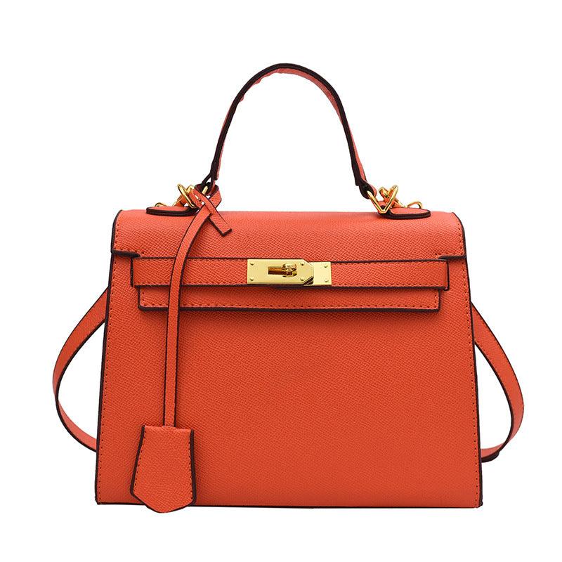 Luxury Cowgirl Kelly Purse – Trendy, High-Fashion Leather Handbag with Adjustable Strap in vibrant orange with buckle lock design