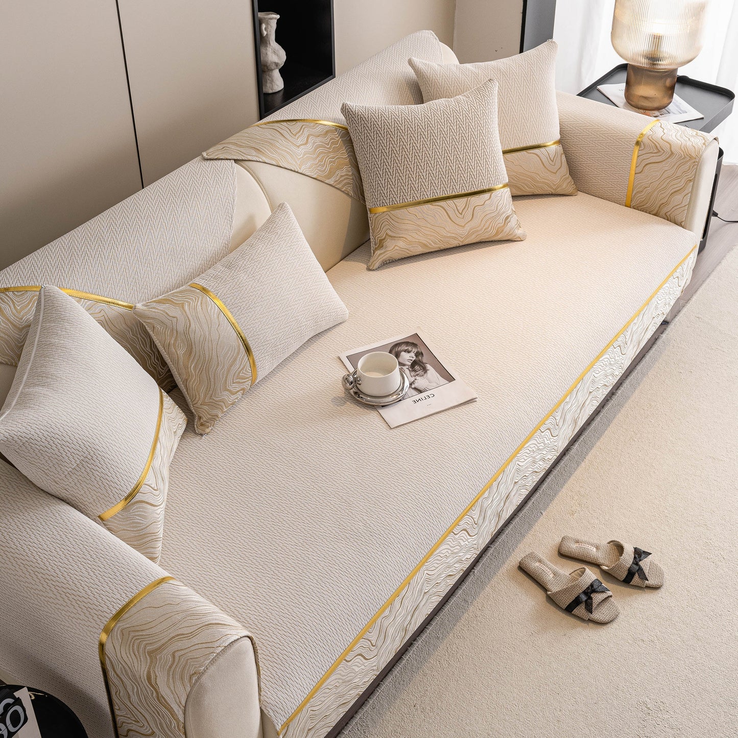 Non-Slip Couch Cover with Gold Trim, Sofa Slipcover for Sectional & Loveseat on beige sofa with pillows and gold accents.