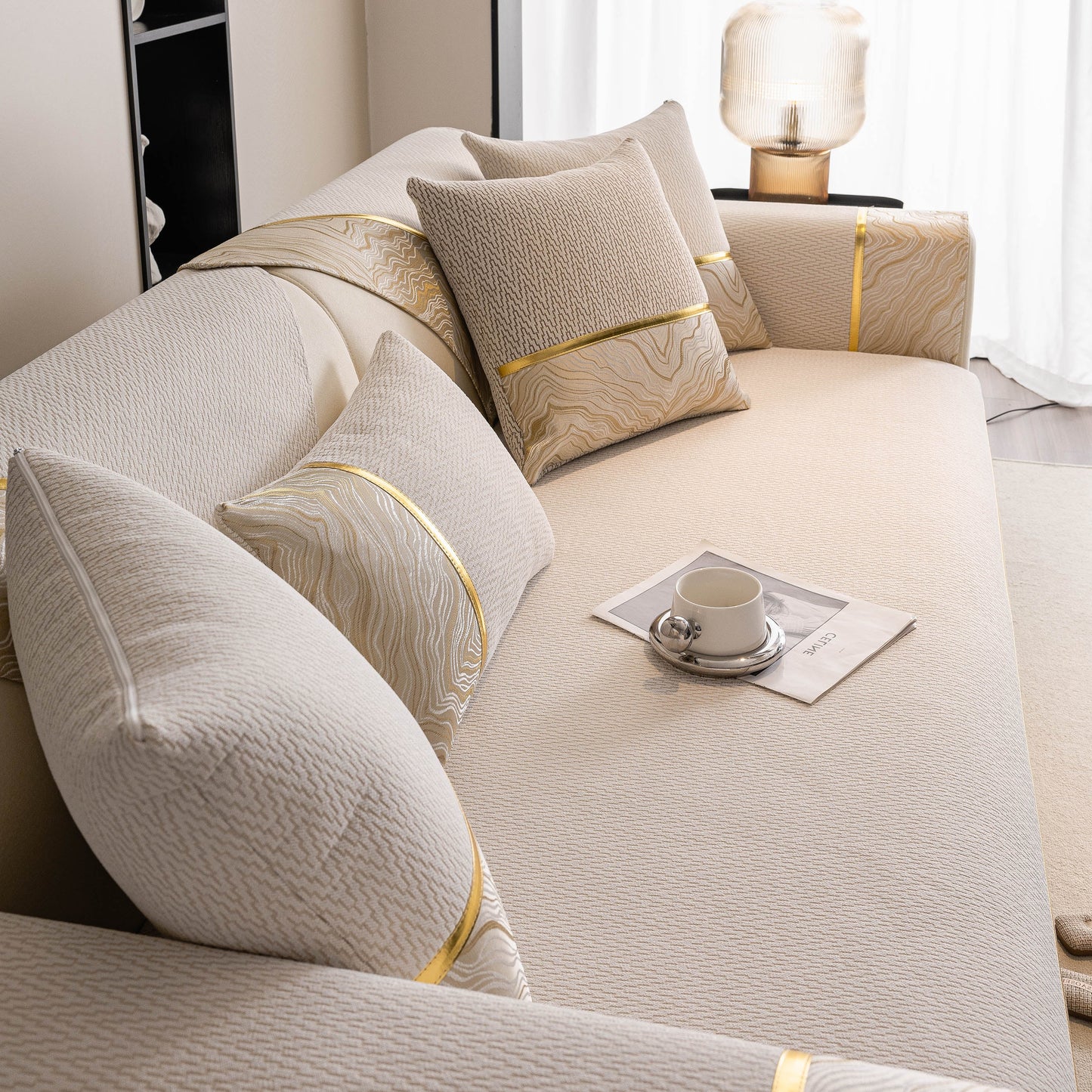 Elegant Non-Slip Couch Cover with Gold Trim on a sectional sofa, featuring chenille fabric and anti-slip silicone dots, ideal for all seasons.