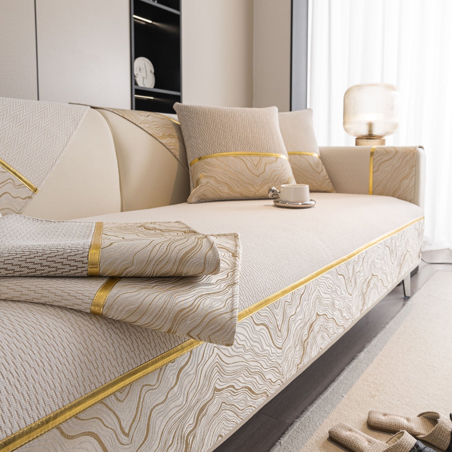 Non-Slip Couch Cover with Gold Trim, Sofa Slipcover for Sectional & Loveseat on beige sofa with cups and pillows