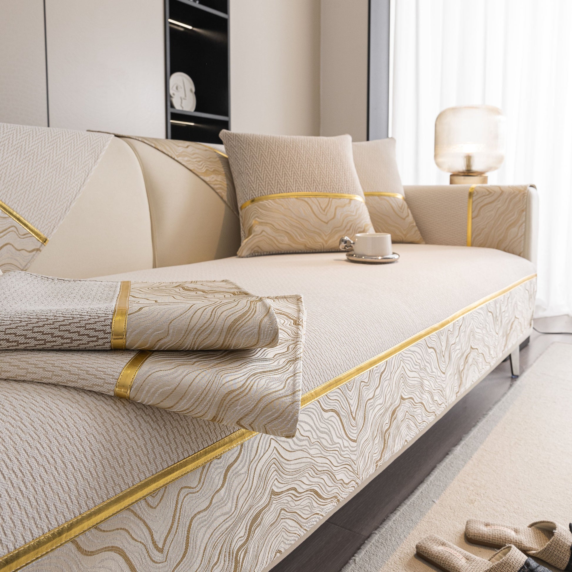 Non-Slip Couch Cover with Gold Trim, Sofa Slipcover for Sectional & Loveseat on beige sofa with cups and pillows