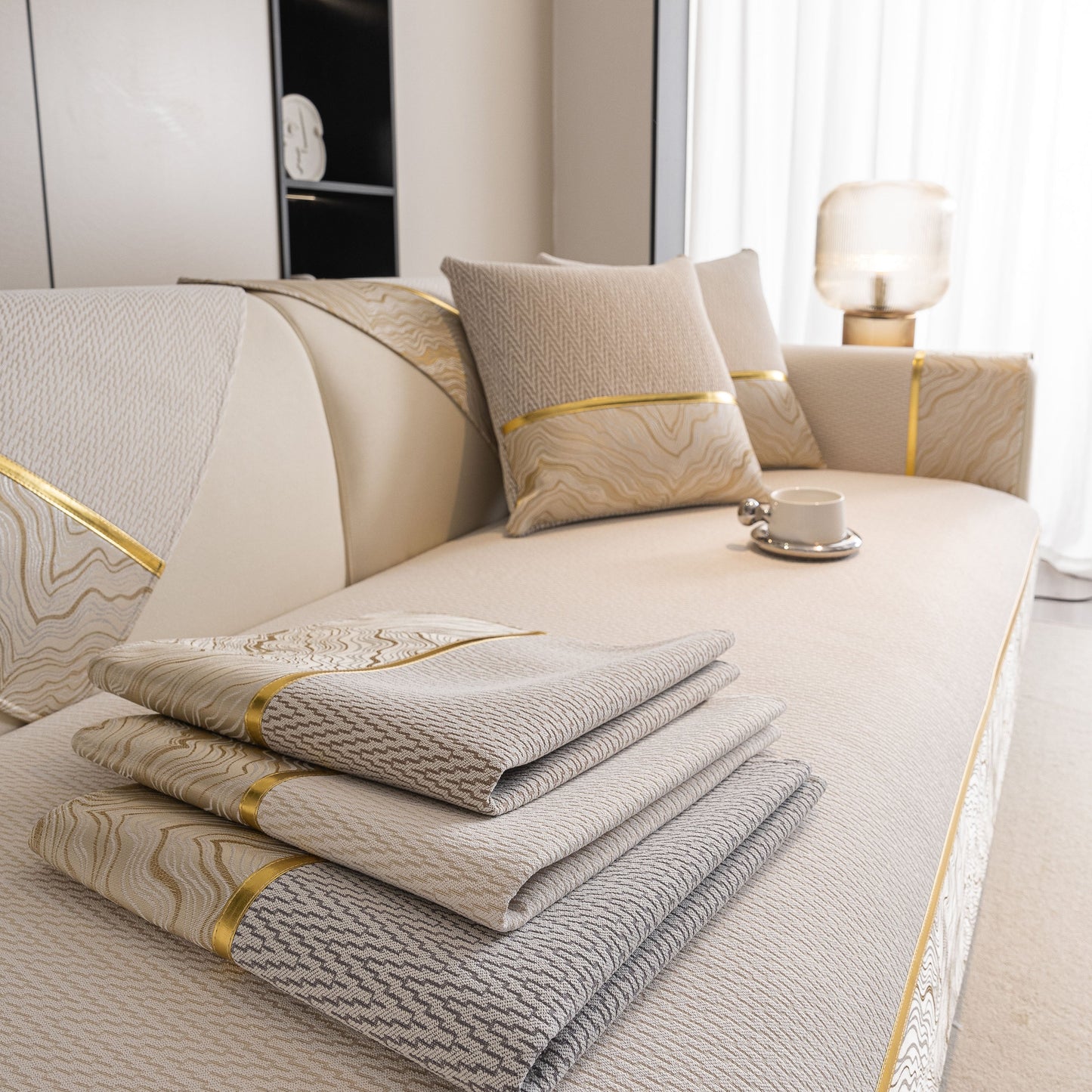 Non-Slip Couch Cover with Gold Trim, Sofa Slipcover for Sectional & Loveseat displayed elegantly on a beige couch