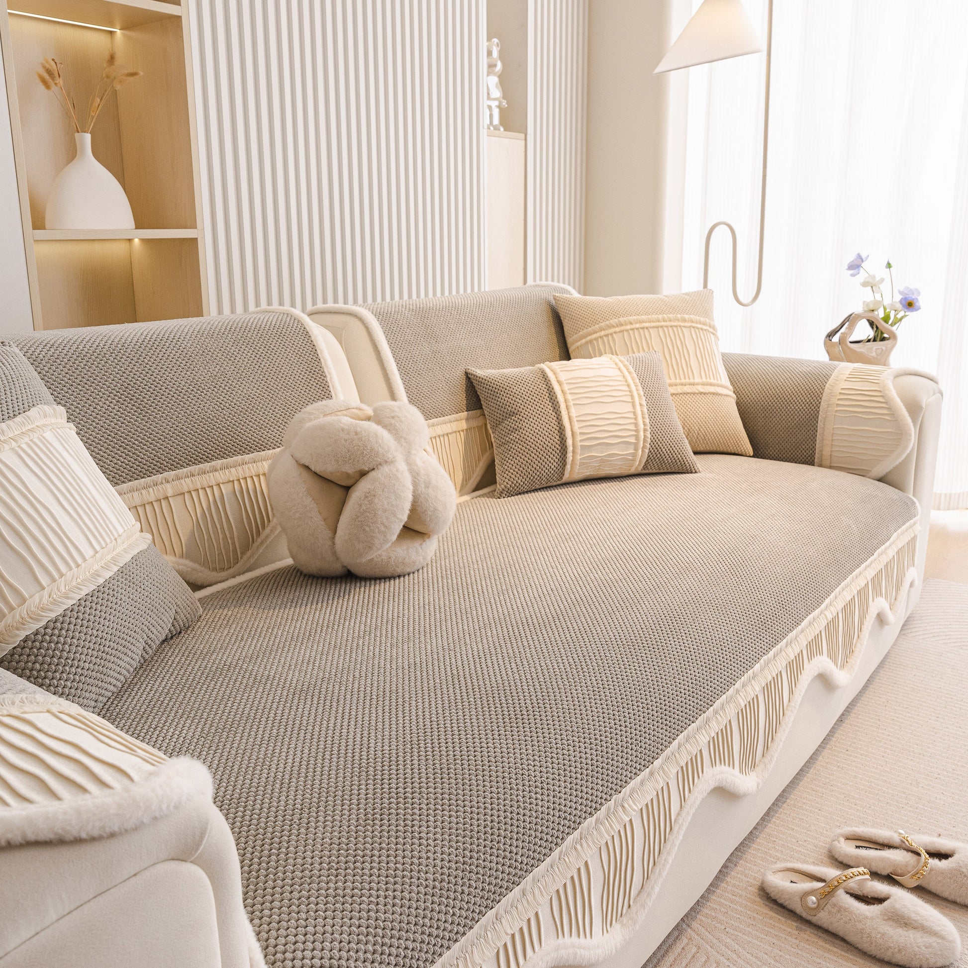 Dog Washable Sofa Protector Cover, Non-Slip Couch Slipcover with Soft Furry Trim in beige with pillows on a beige sofa.