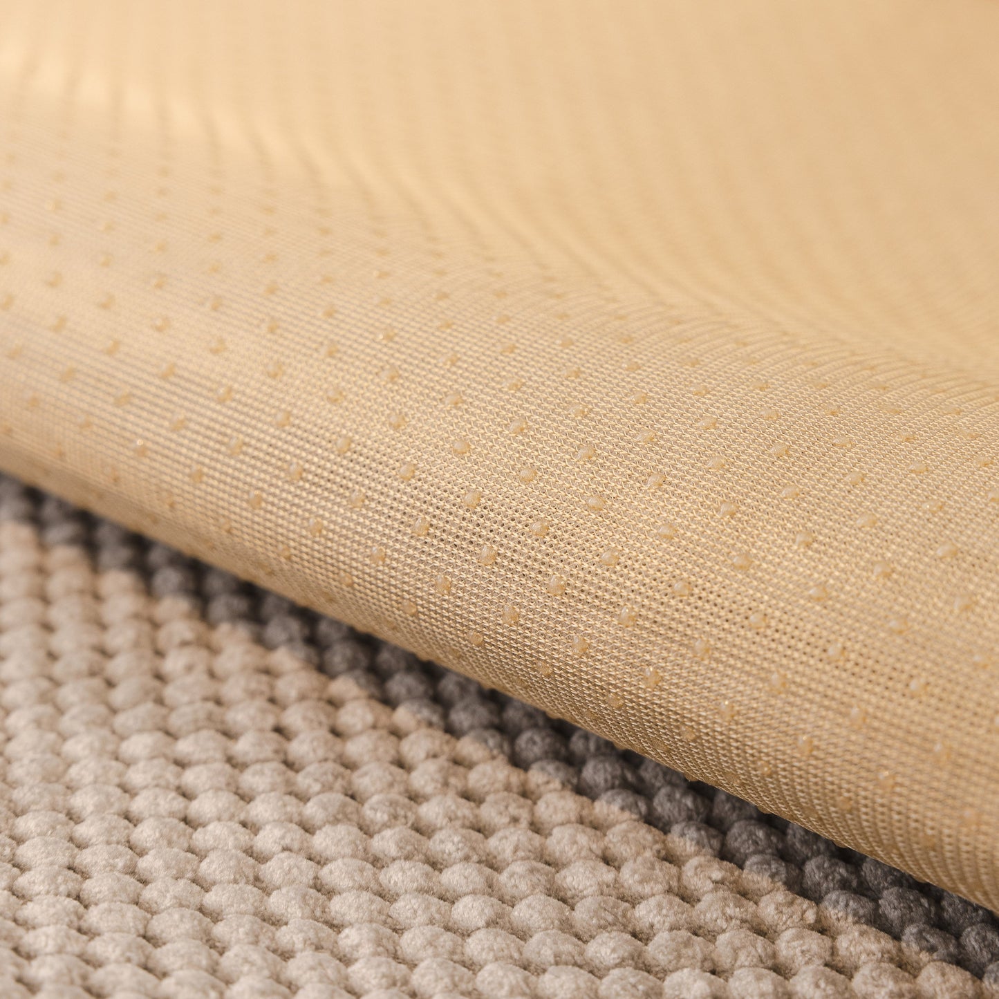 Close-up of the non-slip silicone back of a Dog Washable Sofa Protector Cover with honeycomb texture and soft furry trim.