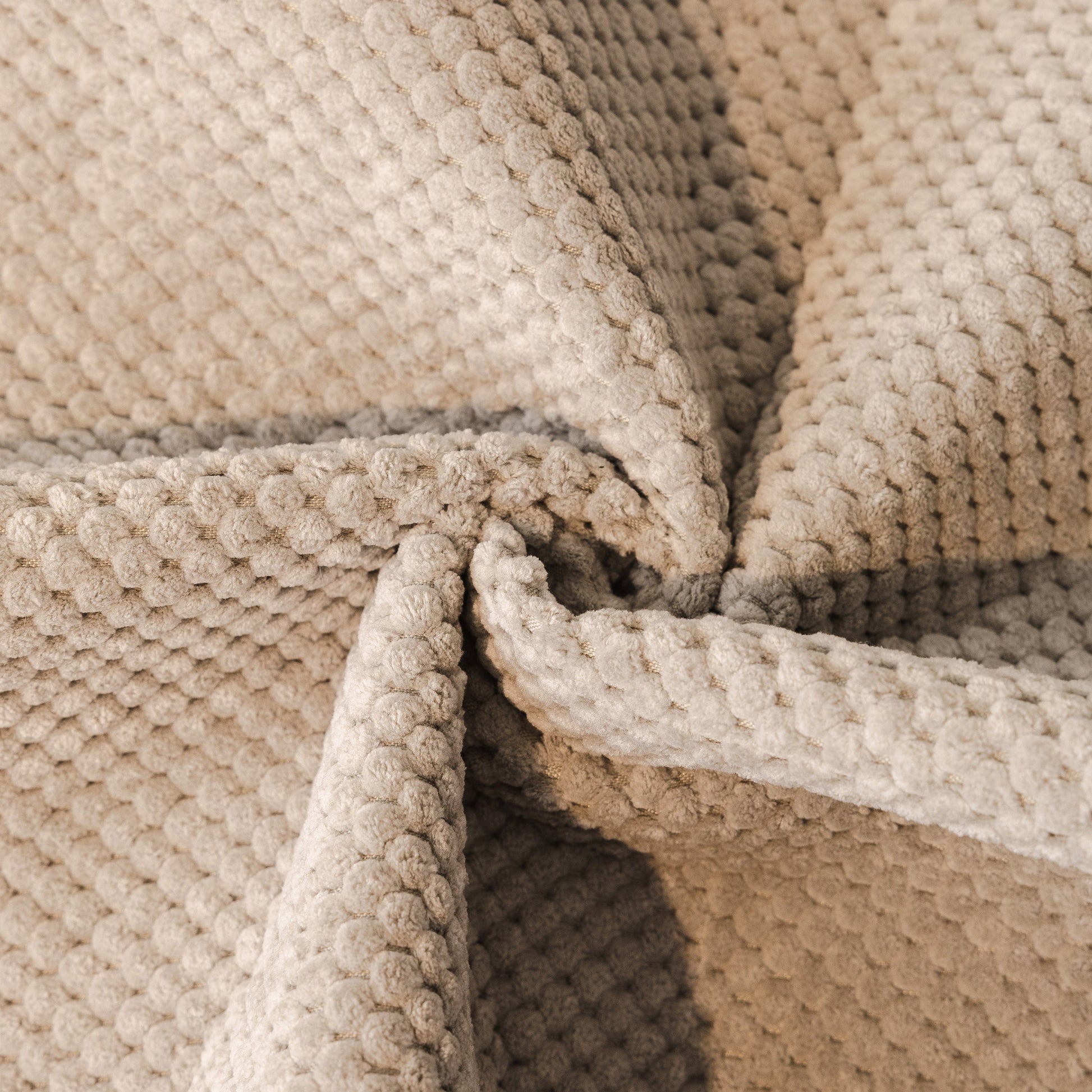 Close-up of beige honeycomb texture on Dog Washable Sofa Protector Cover, Non-Slip Couch Slipcover with Soft Furry Trim.
