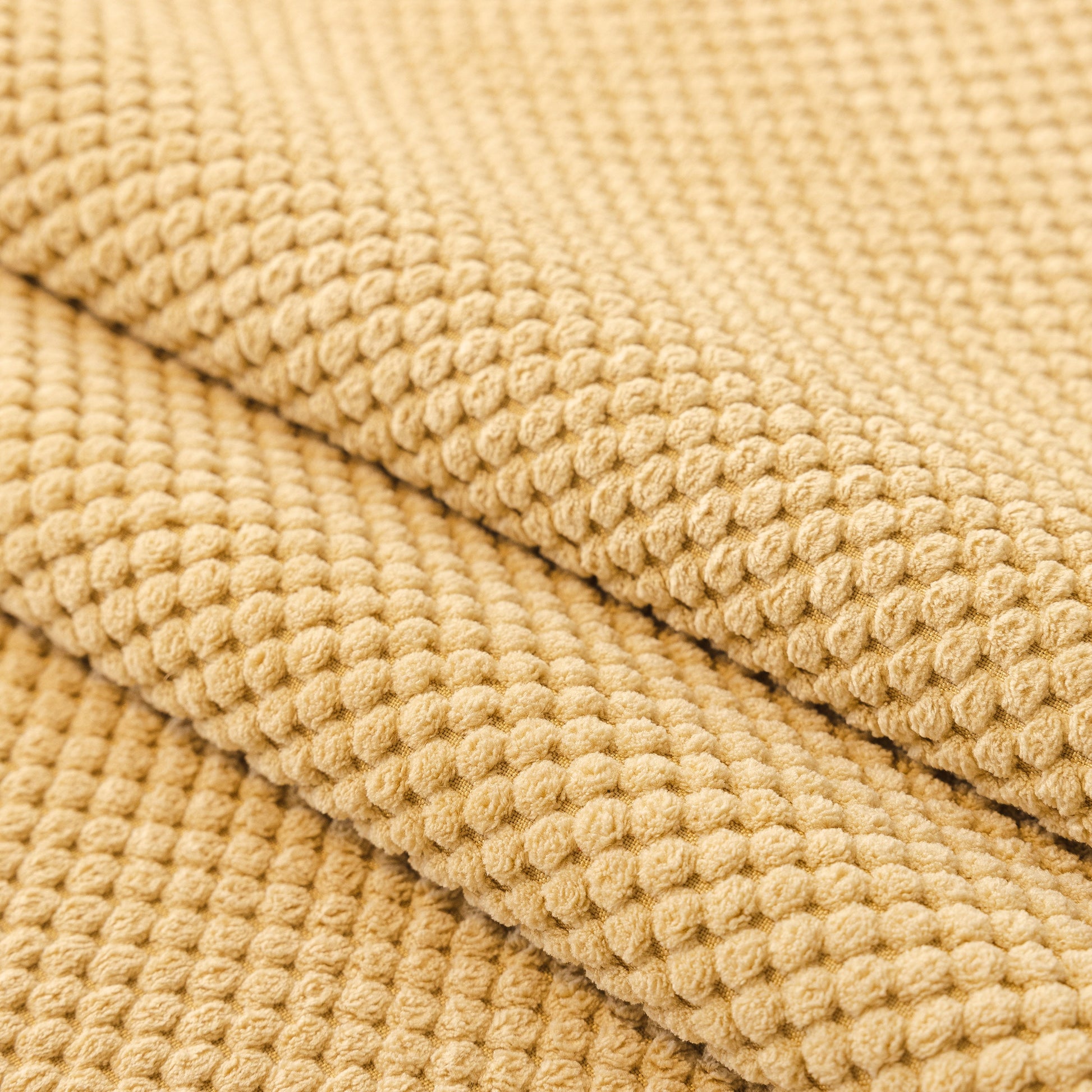 Close-up of beige honeycomb texture fabric for Dog Washable Sofa Protector Cover, Non-Slip Couch Slipcover with Soft Furry Trim.