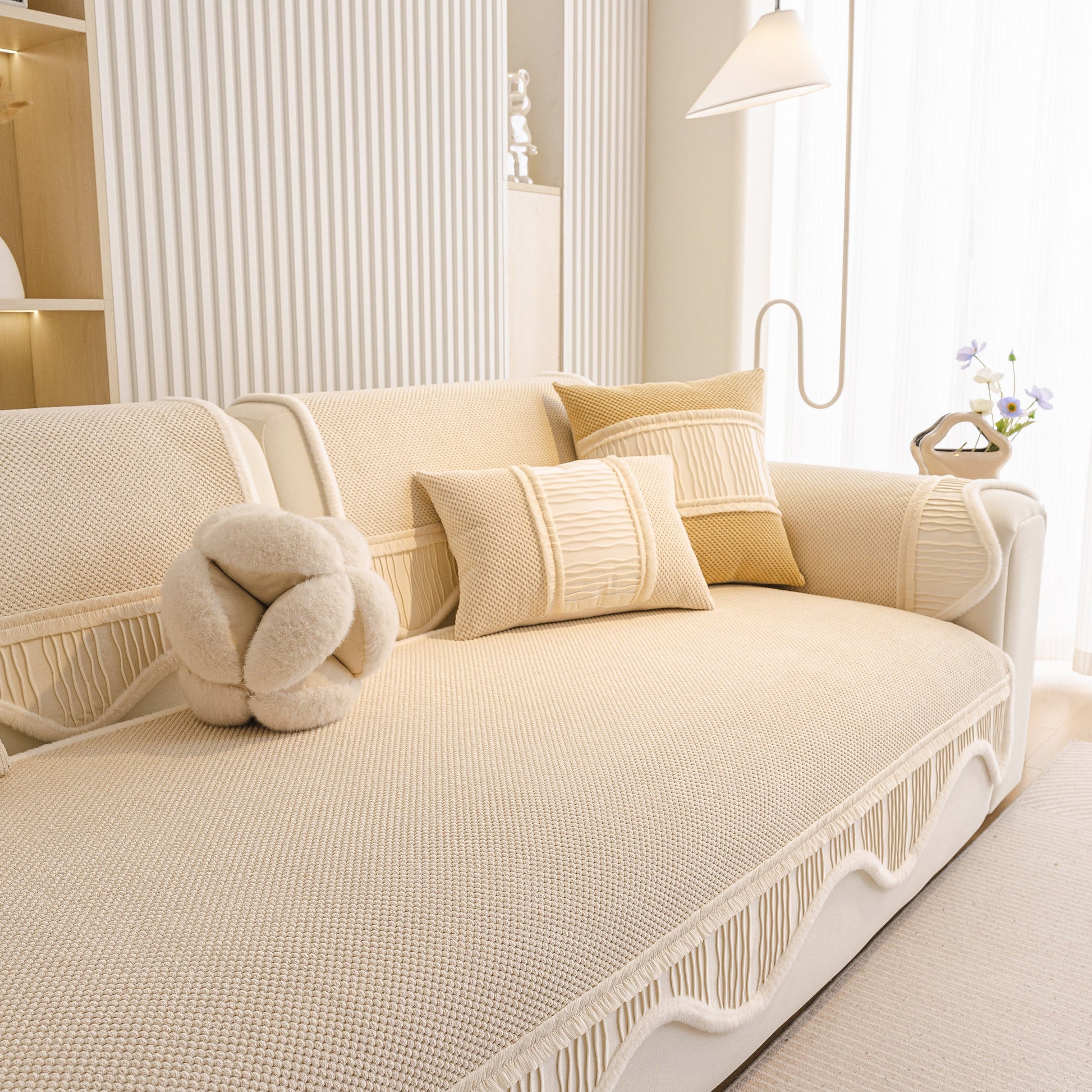 Dog Washable Sofa Protector Cover, Non-Slip Couch Slipcover with Soft Furry Trim in beige on a modern sofa with pillows.