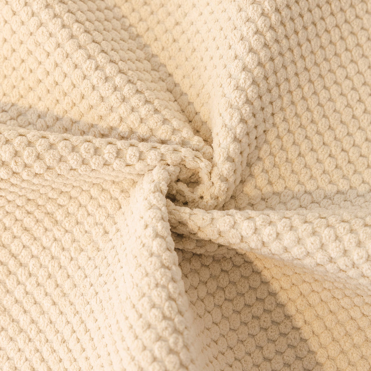 Close-up of beige Dog Washable Sofa Protector Cover, Non-Slip Couch Slipcover with Soft Furry Trim, showcasing honeycomb texture.