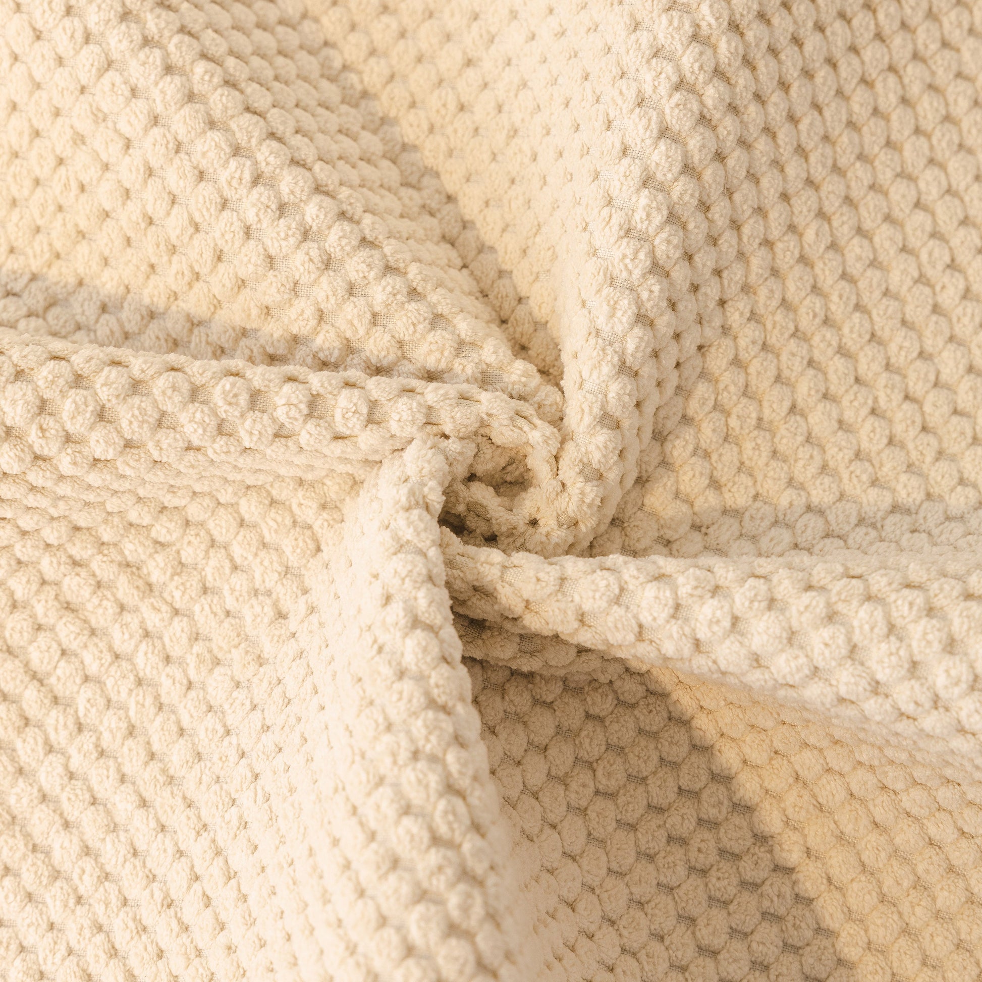 Close-up of beige Dog Washable Sofa Protector Cover, Non-Slip Couch Slipcover with Soft Furry Trim, showcasing honeycomb texture.