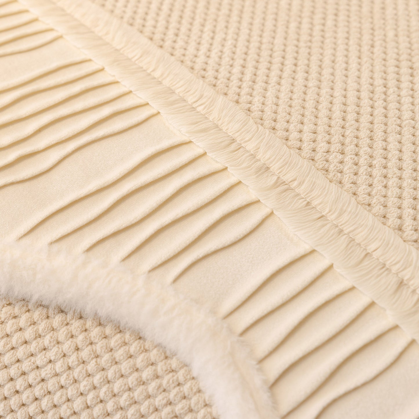 Close-up of beige Dog Washable Sofa Protector Cover, Non-Slip Couch Slipcover with Soft Furry Trim showing texture and pleated edges.