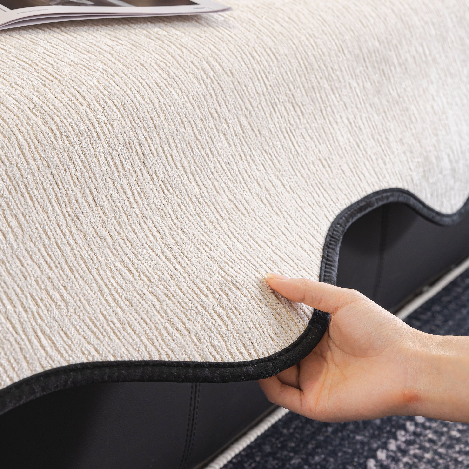 Chenille Couch Cover with Scalloped Edge being adjusted on a sofa, showing non-slip modular slipcover detail