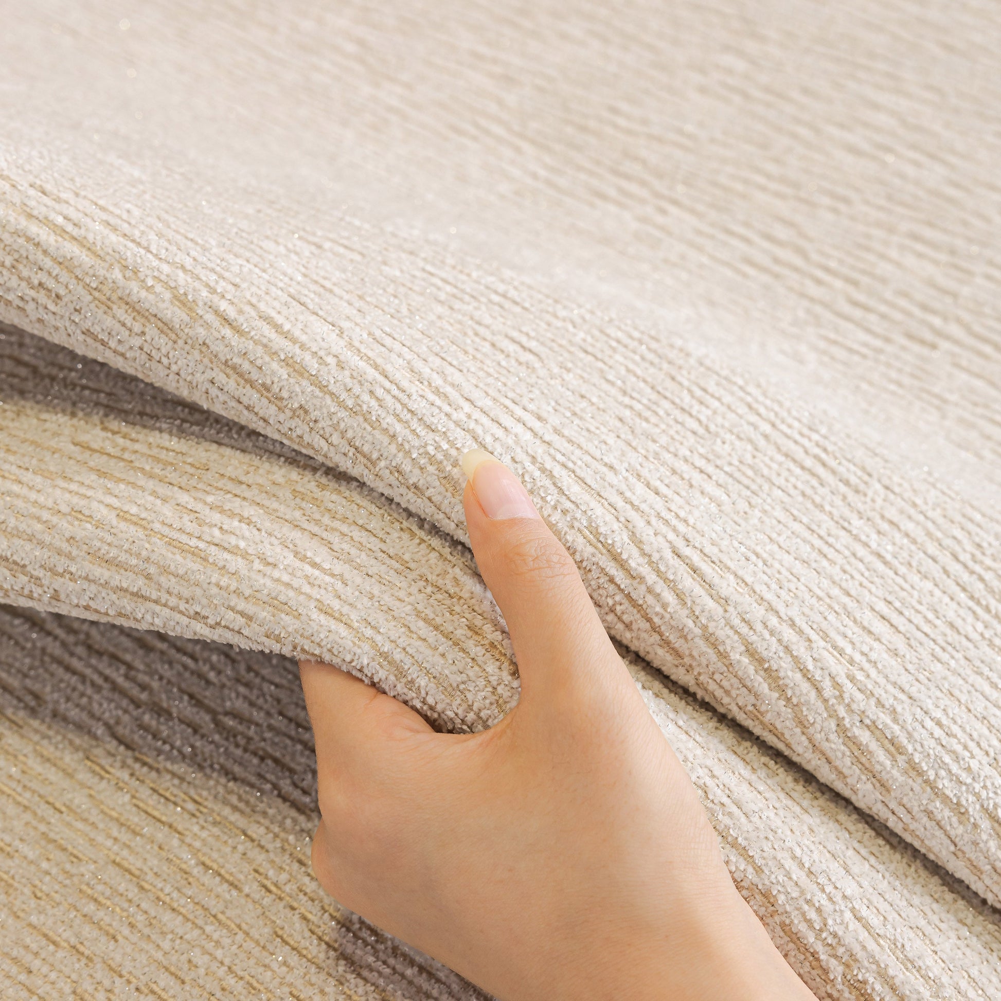 Hand holding premium Chenille Couch Cover with Scalloped Edge, Non-Slip Modular Slipcover Sectional showcasing plush texture