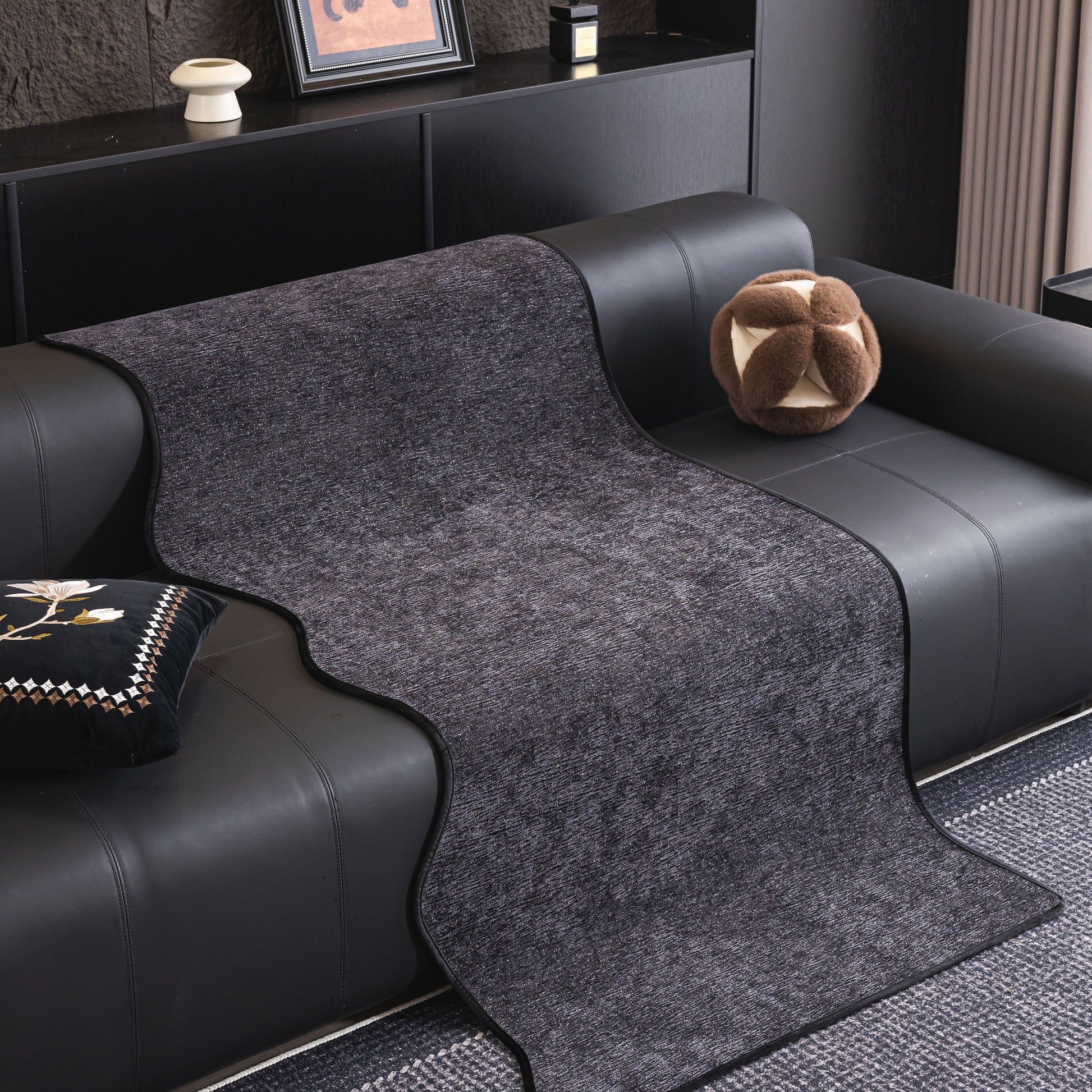Chenille Couch Cover with Scalloped Edge, Non-Slip Modular Slipcover Sectional on black leather sofa in modern living room