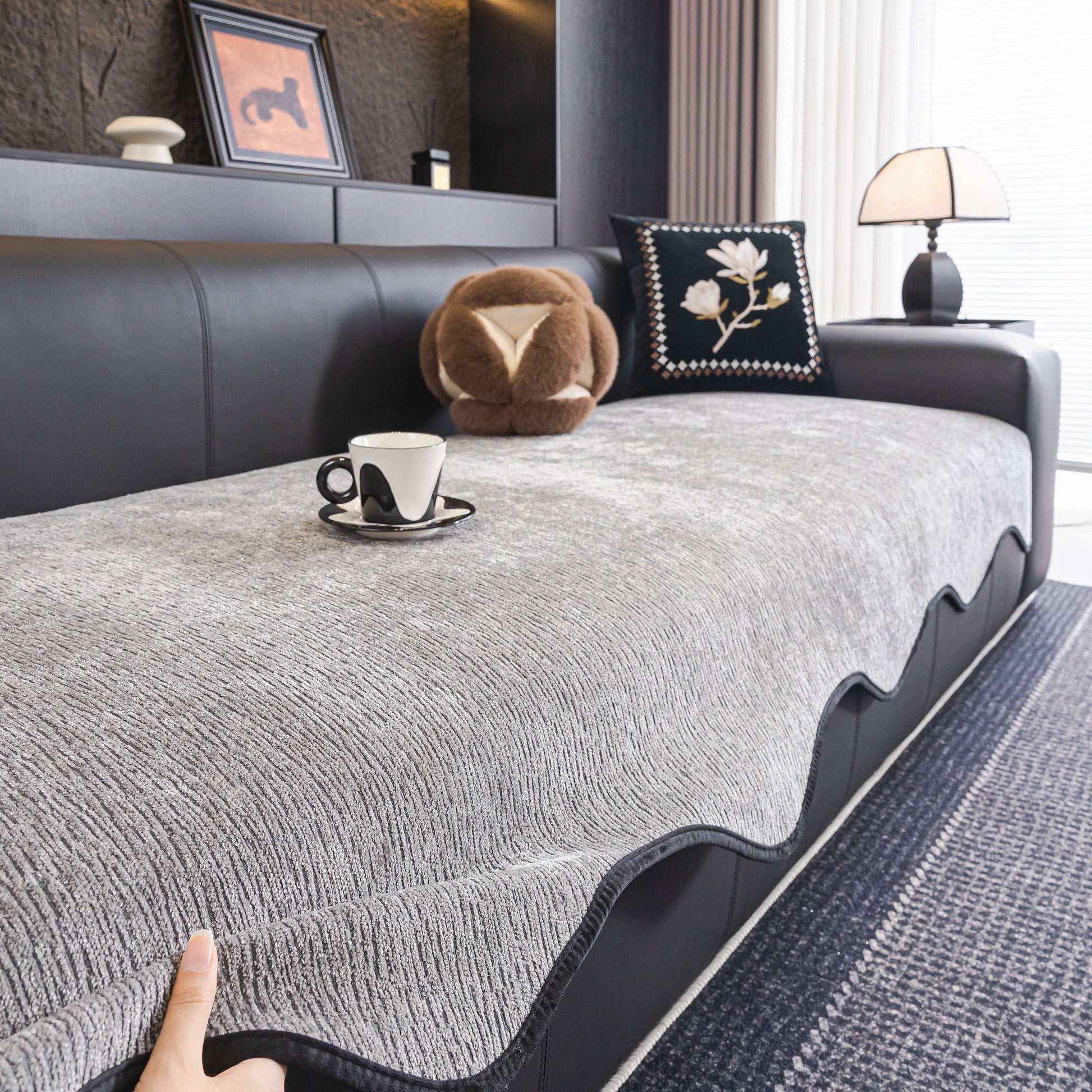 Chenille Couch Cover with Scalloped Edge, Non-Slip Modular Slipcover Sectional on a black leather sofa