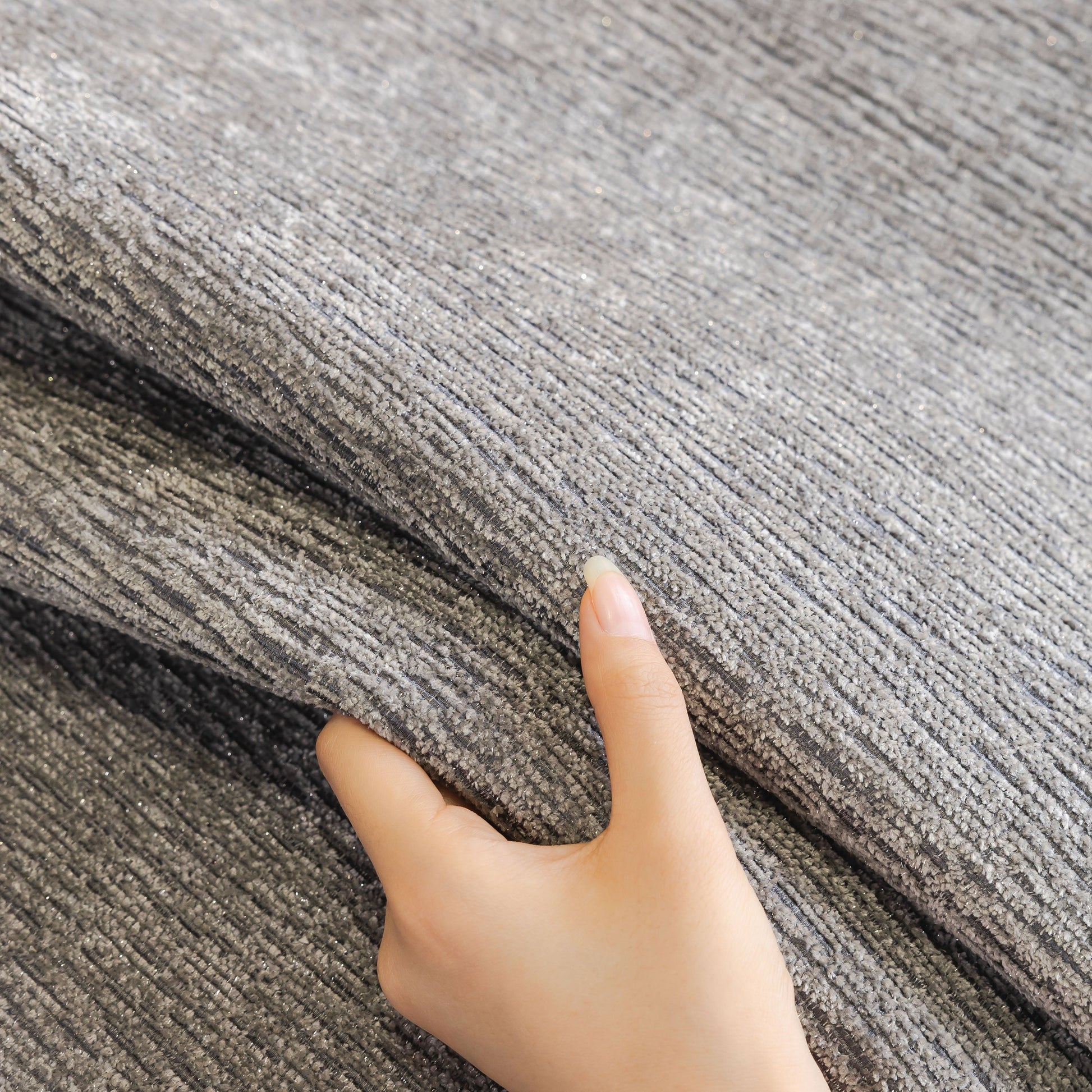 Hand touching Chenille Couch Cover with Scalloped Edge, Non-Slip Modular Slipcover Sectional
