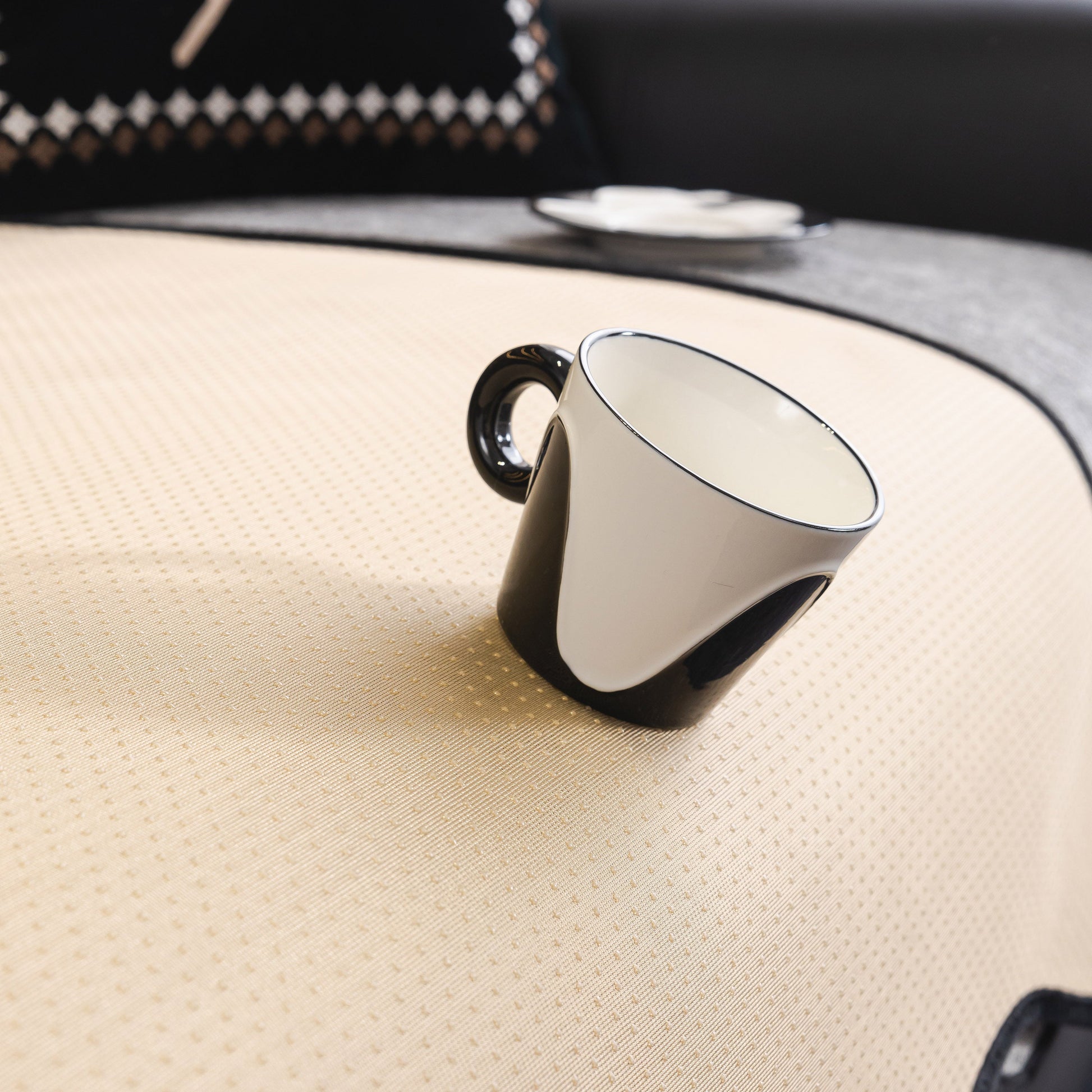 Chenille Couch Cover with Scalloped Edge, Non-Slip Modular Slipcover Sectional with a stylish black-and-white mug resting on its surface