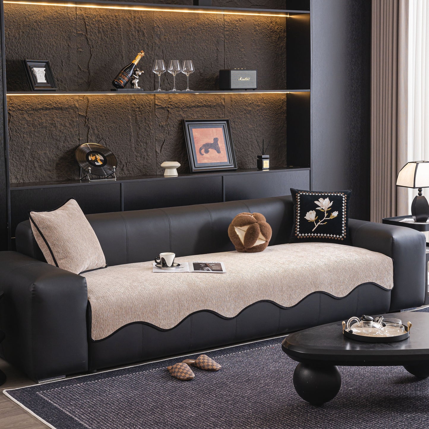 Chenille Couch Cover with Scalloped Edge on black leather sofa in stylish living room.