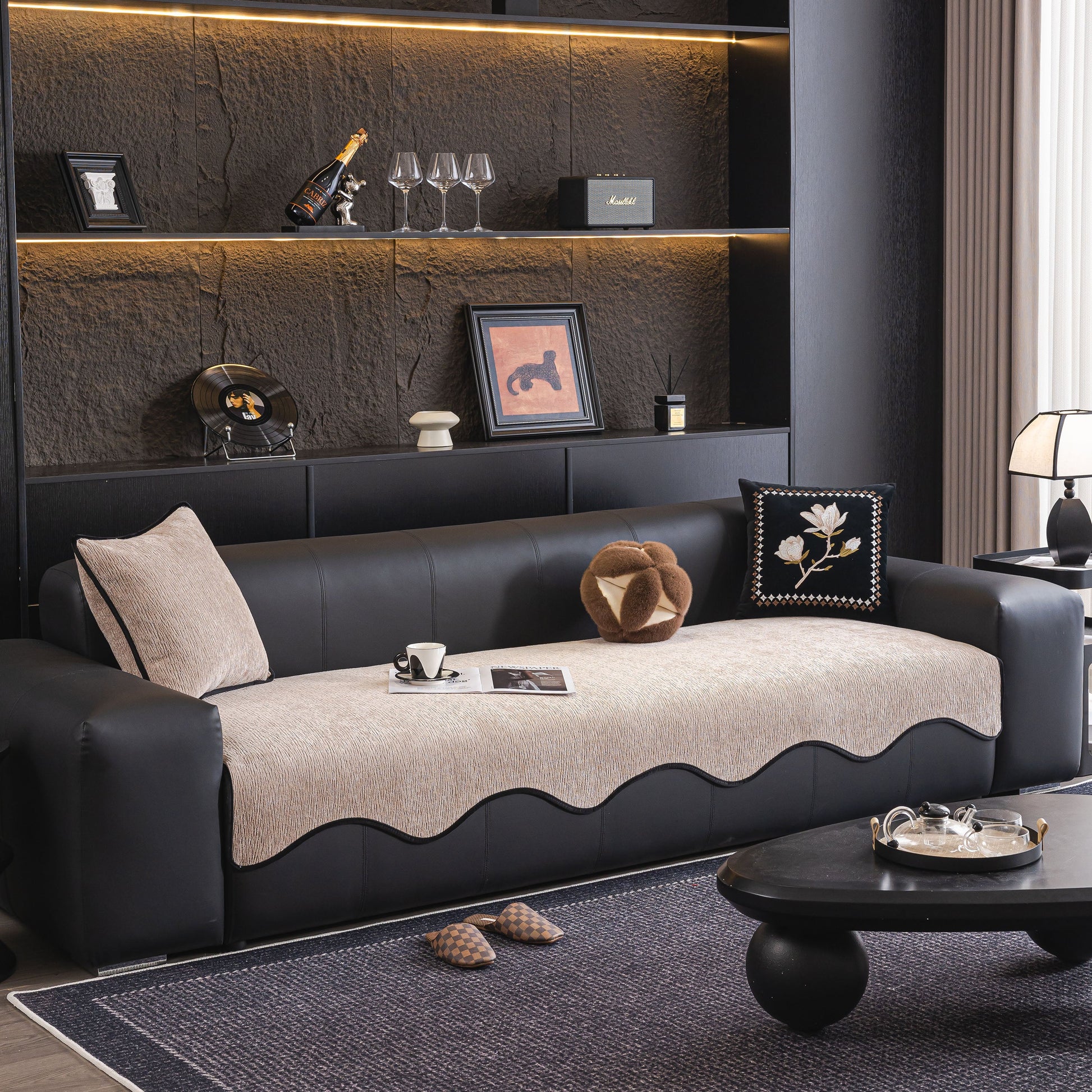 Chenille Couch Cover with Scalloped Edge on black leather sofa in stylish living room.