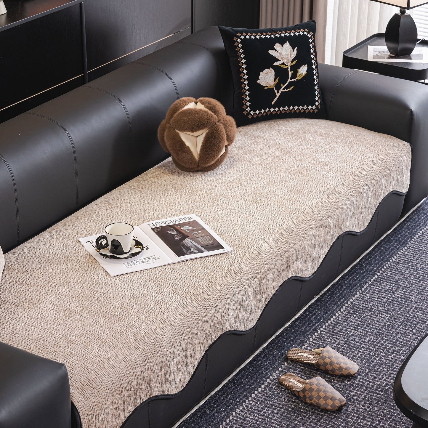 Chenille Couch Cover with Scalloped Edge on leather sofa, showcasing elegant design and plush texture with decorative pillow and magazine.