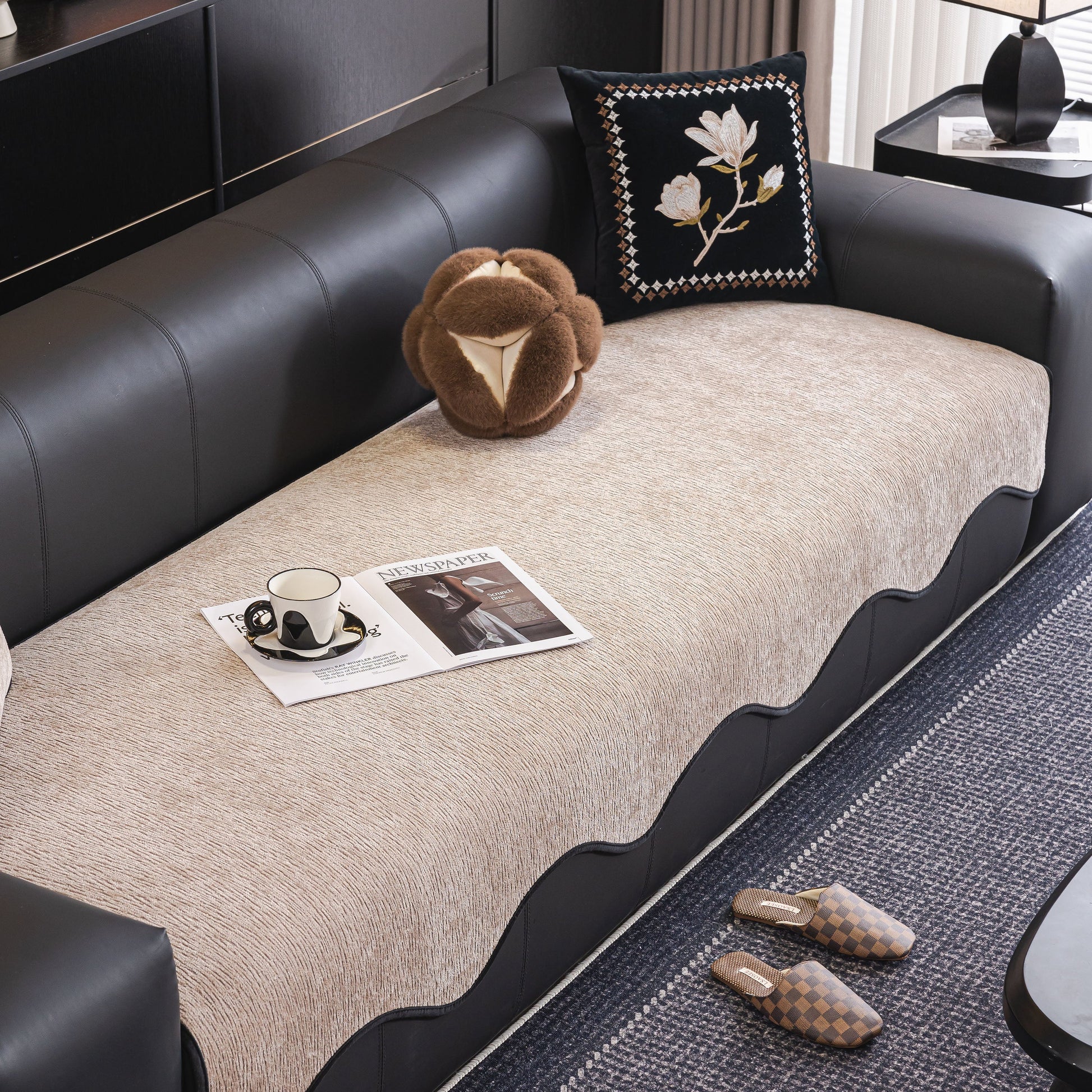 Chenille Couch Cover with Scalloped Edge on leather sofa, showcasing elegant design and plush texture with decorative pillow and magazine.
