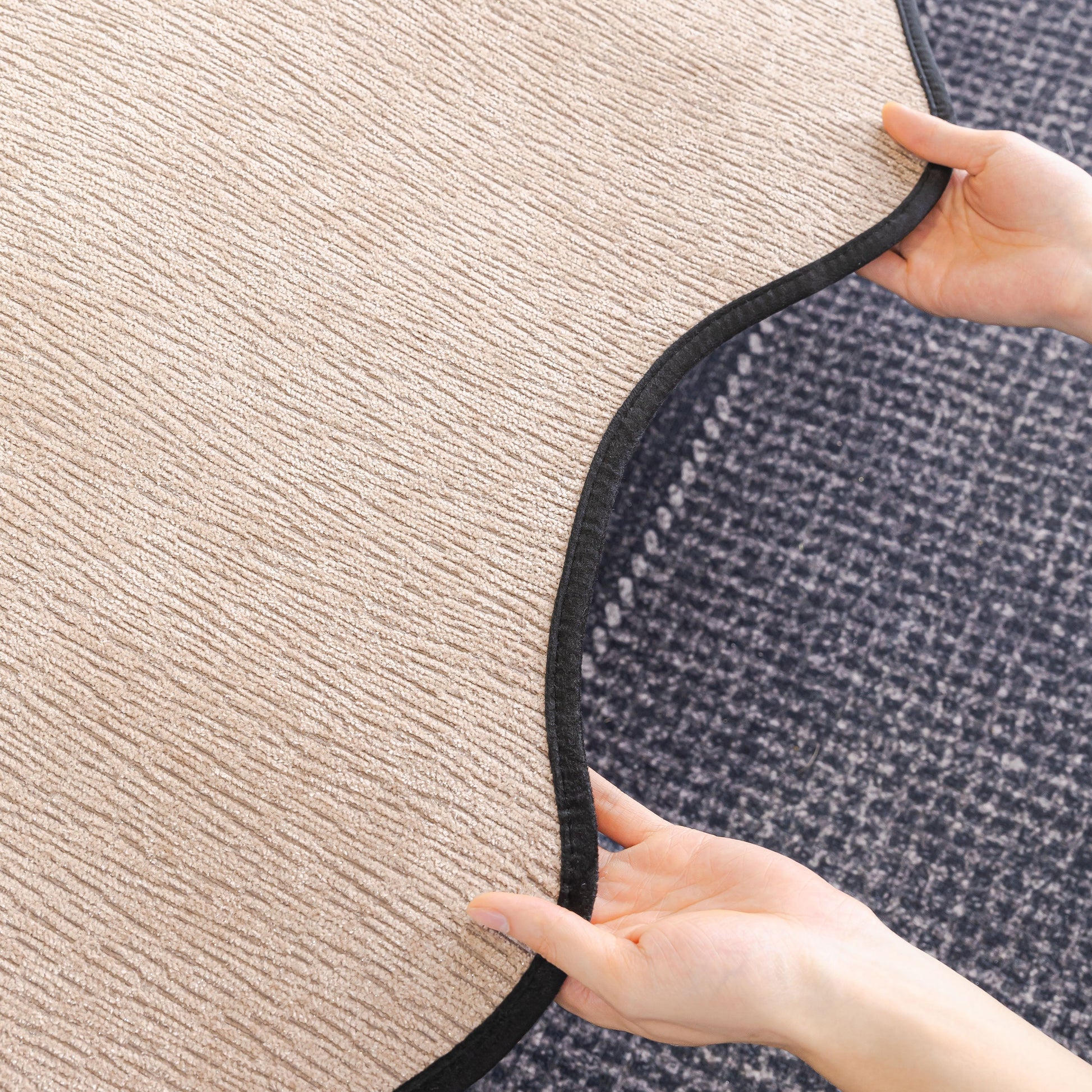 Close-up of Chenille Couch Cover with Scalloped Edge, Non-Slip Modular Slipcover Sectional being unfolded over a sofa corner.