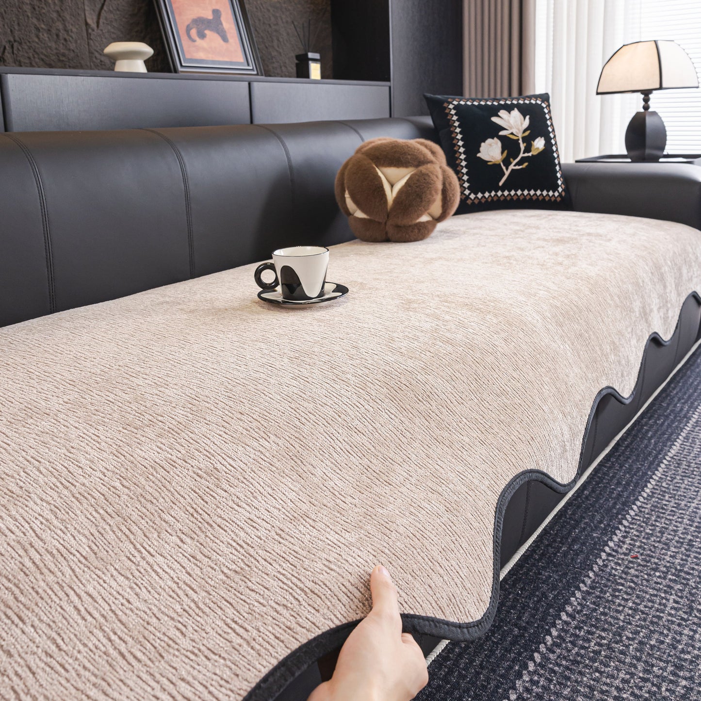 Chenille Couch Cover with Scalloped Edge on black leather sofa, showcasing soft plush texture and elegant wave design.